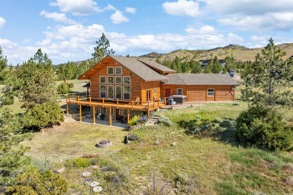 Enjoy spectacular views of Canyon Ferry Lake from this custom-built log home in the desirable Canyon Ferry Crossing Subdivision. Offered fully furnished, this exceptional home is designed for convenient main-level living, featuring the Great Room, kitchen, primary suite, full bathroom, and laundry room all on the main floor.  The spacious Great Room showcases expansive windows that perfectly frame the lake and a stunning floor-to-ceiling gas fireplace, creating a warm and inviting gathering space.  Upstairs, the open loft overlooks the Great Room below and provides the perfect space for a home office, reading nook, or sitting area while taking in the incredible lake views. Two additional bedrooms and a 3/4 bathroom complete the upper level.  The walkout lower level is ideal for guests or entertaining, offering a spacious family room with a kitchenette featuring a refrigerator and sink, a fourth bedroom, and another 3/4l bathroom.  In-floor radiant heat provides efficient, comfortable warmth throughout the home (not in the utility room).  An oversized two-car garage includes a dedicated workshop area, offering plenty of space for storage, hobbies, or projects. With paved roads all the way from Helena, this beautifully crafted log home combines rustic elegance, modern comfort, and breathtaking lake views, making it the perfect year round residence or mountain retreat.