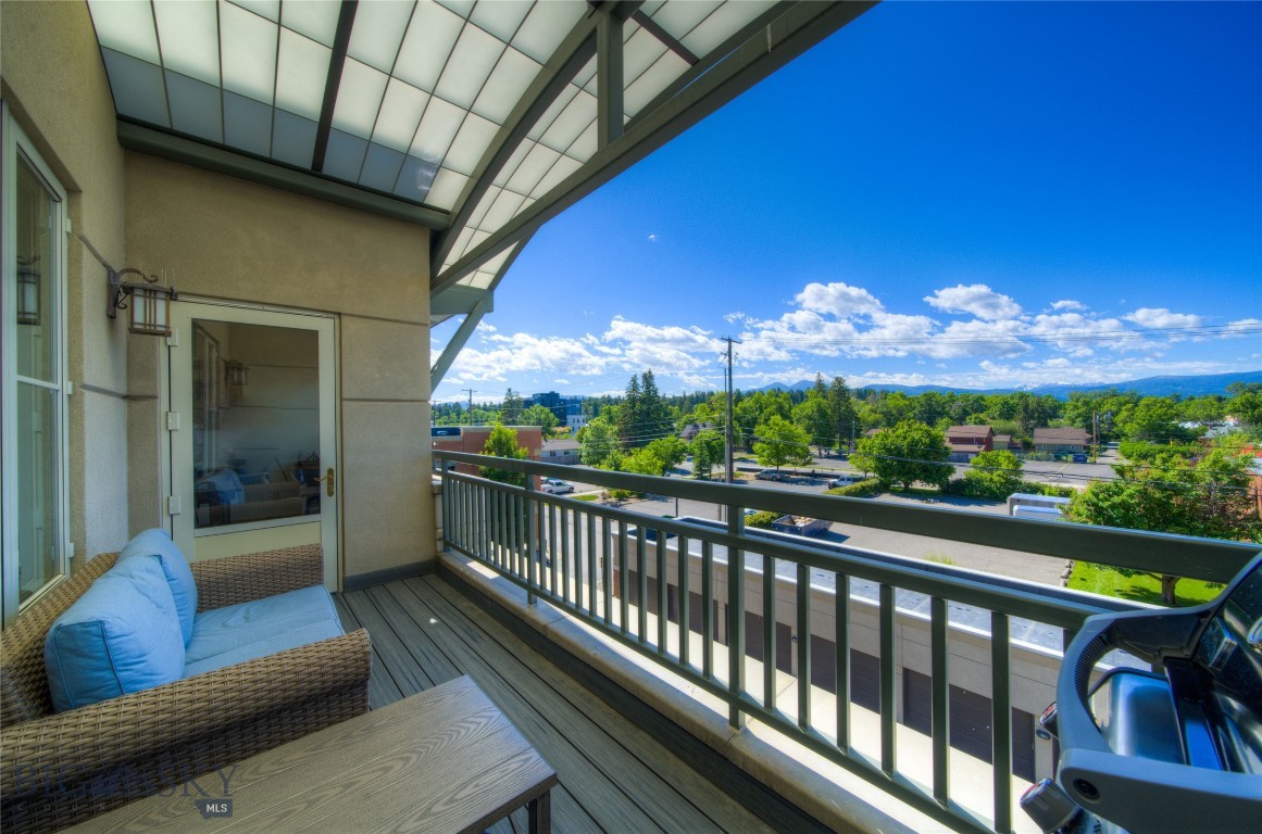 Experience the perfect blend of vibrant downtown living and peaceful privacy in this beautifully situated condo on Main Street in Bozeman. Located on the quiet rear side of the building, this residence offers a serene retreat from the energy of downtown while placing restaurants, shopping, and entertainment just steps from your door. A rare opportunity to enjoy both convenience and tranquility in the heart of the city. This inviting 2 bedroom, 2 bathroom residence features hardwood floors, in-unit laundry, and a private balcony showcasing stunning views of the Gallatin Range. The thoughtfully designed kitchen offers upscale appliances, ample countertop space, and abundant cabinetry—perfect for everyday living or entertaining guests. Both bedrooms feature generous closet space, creating a comfortable and functional layout that truly feels like home. Security and exclusivity are unmatched, with private third-floor access requiring a code from both the elevator and stairwell. With only six residential units in the building, residents enjoy a quiet, boutique-style living experience in the heart of downtown. Additional highlights include one detached garage parking stall located within the garage structure and 30-day minimum rentals allowed, offering flexibility for owners or investors alike.