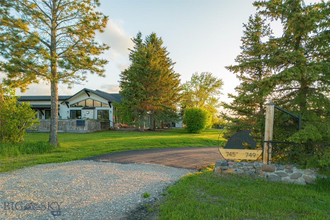 Dream Home with Breathtaking Views & Designer Touches. Welcome to your mountain-modern retreat! This stunning, fully remodeled home blends rustic charm with elegant finishes in every corner. Step inside to discover a spacious open floor plan flooded with natural light from walls of windows. The heart of the home is a chef’s kitchen designed to impress—with top-of-the-line appliances, custom cabinetry, a generous island, & plenty of built-in storage for a clean, effortless look. Whether you're entertaining guests or enjoying a cozy night in, the south facing wall of windows will grace you with a stunning view of the Spanish Peaks making this space perfect for every occasion. Rustic wood beams, high-end finishes, & thoughtful details throughout create a warm inviting ambiance. The oversized fireplace with stone hearth in the living room beckons for you to sit & warm yourself while enjoying a cocktail made at the wet bar. Additional interior features include a true office, all ensuite bedrooms, basement theatre room & gym space. Multiple decks & outdoor living spaces, complete with hot tub, offer the ideal spots to take in the sunrise, host gatherings, or simply relax & enjoy the views. The yard is surrounded by hedges for privacy, a mature lawn, with towering pines that create an alpine feel. The sprinkler system was installed last fall to allow for any further landscaping you could dream up. The guest home is the charming original ranch home that was recently moved to a new foundation, provided with it’s own well (100 GPM) & septic. The 2 bed, 2 bath home with attached garage could provide a place for additional family, a caretaker, or produce income as a rental. Set on 20 pristine acres, already divided into (2) 10 acre parcels, this property has been meticulously maintained as horse pasture—sprayed annually & carefully under-grazed to preserve its health & productivity. It's ready for your livestock, with a versatile barn already designed with horse stalls in the back & a workshop up front. Whether you’re an equestrian, hobby farmer, or just seeking wide-open space, the possibilities here are endless. With no covenants, no HOA, & no subdivision restrictions, you're free to build, expand, or reimagine the property entirely to suit your vision. This home is a rare find—move-in ready, beautifully finished & designed for comfort & style, all within 10 minutes of downtown Bozeman. Don’t miss your chance to own a one-of-a-kind property that truly has it all!