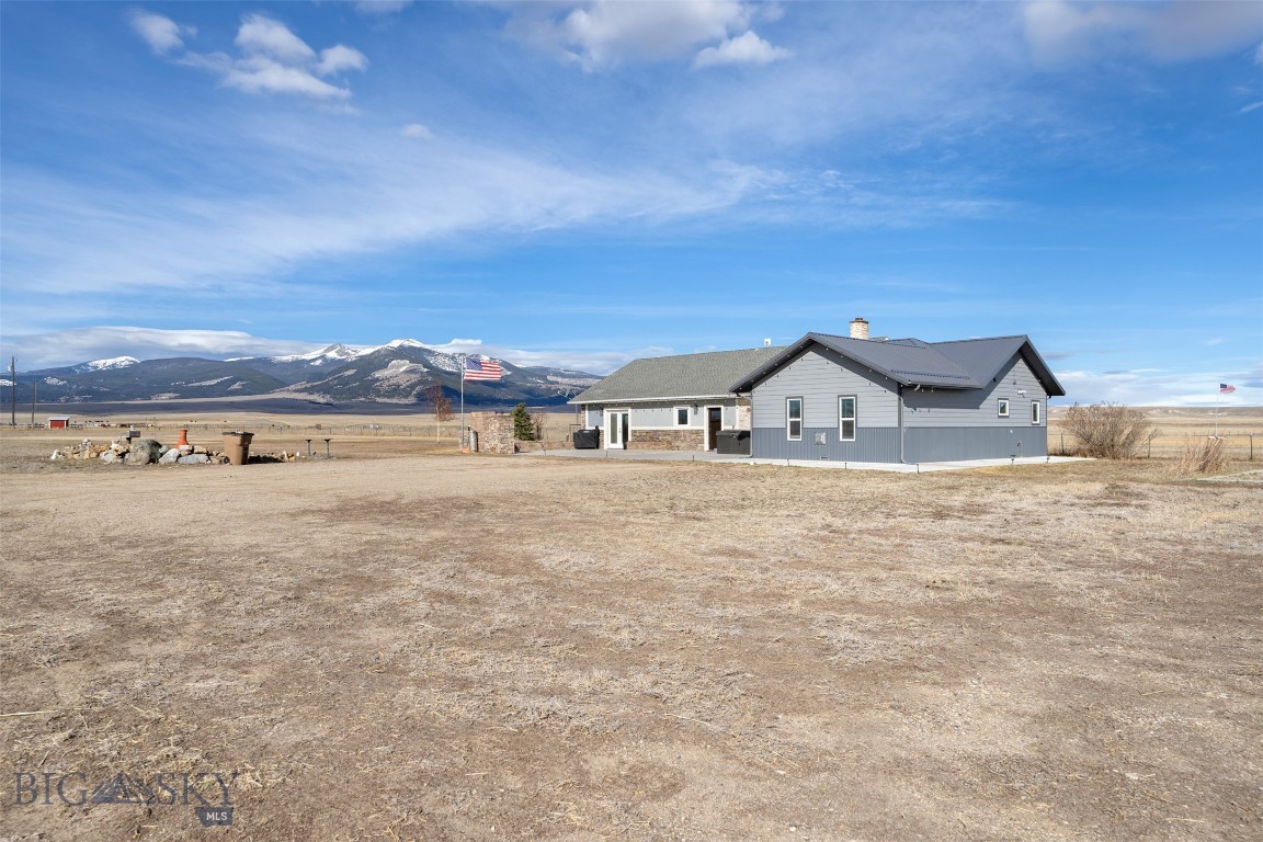 Two parcels, nearly 8 acres, and views that'll stop you in your tracks. 110 and 90 Mountain View Ln together make up one of those rare finds that checks every box.
The main home at 110 Mountain View Ln sits on 3.71 acres and keeps things simple with single-level living. You'll find a spacious primary suite with a walk-in closet and private ensuite, three additional bedrooms, a full bath, and a living room with a fireplace for those Montana winters. The kitchen is bright, the views are constant, and the patio just off the kitchen has a built-in grill and a hot tub ready to go. There's also a bar area with a kegerator, because, why not. The oversized 3-car garage comes with a dedicated game hanging room and meat cutting room, a thoughtful feature for those who appreciate the outdoor lifestyle this area offers. The second parcel at 90 Mountain View Ln adds 3.99 acres to the mix, along with an oversized 2-car garage/shop and a fully equipped guest house. The guest house has a bedroom, living room, kitchen, and a bathroom with laundry, plus its own well and septic. Whether it's guests, extended family, or a rental opportunity, the setup is already there.
Nearly 8 acres, multiple living spaces, mountain views in every direction. This is Montana living done right.