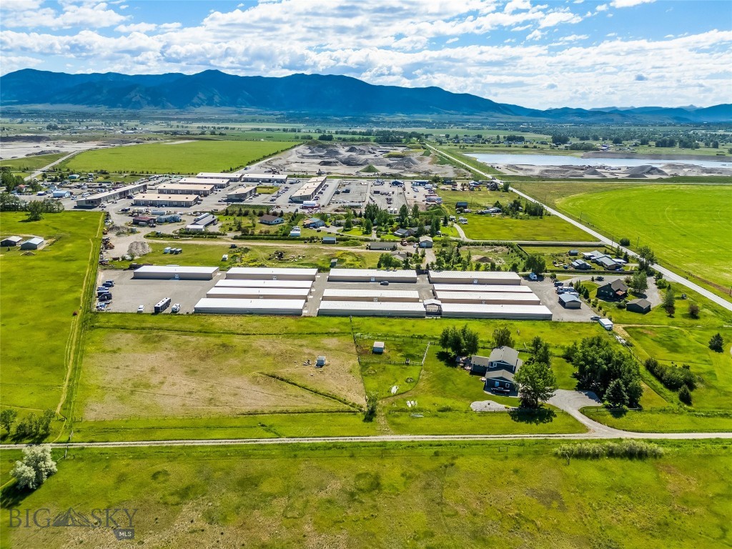 605 E Cameron Bridge Road is a 5.22-acre parcel with an existing 2,500-square-foot residence, located northwest of downtown Bozeman off Jackrabbit Lane. The site is within minutes of Bozeman Yellowstone International Airport and the Highway 191 corridor. No HOA. Private well and septic in place.
The existing structure is a two-story, three-bedroom, 2.5-bath home built in 1992 with an 800-square-foot attached two-car garage. It is currently habitable and could support owner-occupancy, a caretaker arrangement, or interim rental while a buyer evaluates longer-term use. Forced air gas heat, asphalt roof, engineered wood and tile flooring throughout most of the main level.
The land is the asset. Five-plus contiguous acres this close to downtown Bozeman and the airport does not come together often. The site is flat, partially fenced, with a ditch water amenity on or touching the property. A gravel driveway and dirt/clay road access serve the parcel currently. Mountain views to the south and west.
5.22 acres. Existing 2,500 SF structure with garage. Private well and septic. No HOA or subdivision restrictions noted. 2025 property taxes: $3,624. Asking $1,350,000. Buyer to verify zoning and allowable uses with Gallatin County.