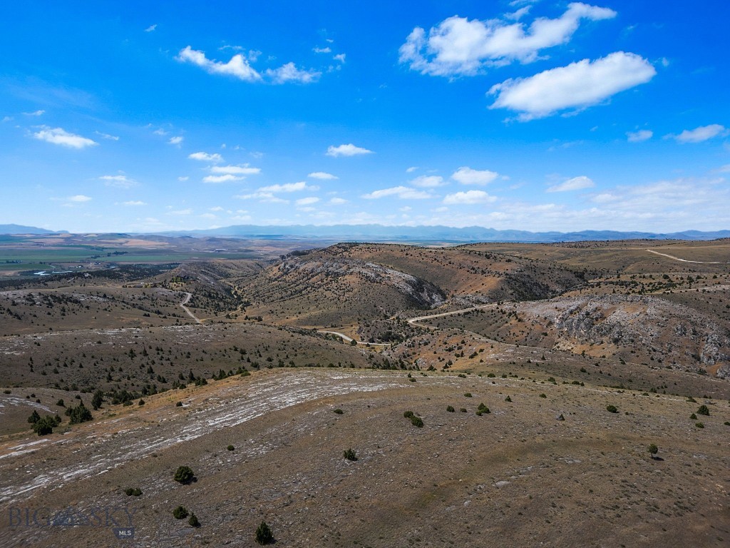 Welcome to 19.85 acres of pristine Montana beauty in the sought-after Gallatin River Ranch community, just minutes outside of Manhattan. This expansive parcel offers the perfect blend of privacy, open space, and access to nature. Bordering a public state section along its northern boundary, this lot offers an extended sense of seclusion and recreational opportunity right out your back door. Gaze out across stunning southwest views that stretch for miles—an ideal backdrop for your dream home, retreat, or investment. The gently rolling terrain makes for a flexible build site, with ample room for horses, outbuildings, or simply room to breathe. Gallatin River Ranch is a private, 5,900-acre community known for its sweeping views, wildlife, and access to the legendary Gallatin River. Residents enjoy exclusive access to a private stretch of the river for fishing and floating, as well as maintained roads, hiking and riding trails, and a nearby equestrian center. With a highly competitive price point and unmatched surroundings, this is a rare opportunity to own a large slice of unspoiled Montana. Interest in a shared well provides water for domestic use. Don’t miss your chance to be part of this truly special community.