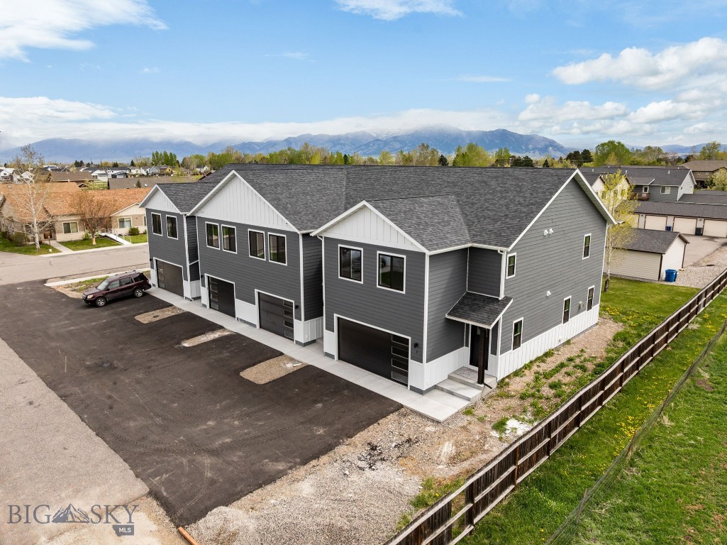 Thoughtfully designed and beautifully finished, this brand-new townhouse in Falcon Hollow offers comfortable living with clean, modern style and mountain views just outside your windows. The open-concept main level creates an inviting space for gathering, featuring warm wood cabinetry, quartz countertops, stainless steel appliances and a spacious island with seating. Large windows bring in abundant natural light while the adjacent dining area flows seamlessly to the patio and backyard space. Upstairs, the huge primary suite offers a peaceful retreat with a dual vanity bathroom, tiled shower, and generous walk-in closet. Two additional bedrooms, a full guest bath, and an upstairs laundry room provide a functional layout designed for everyday living. Additional highlights include vinyl plank flooring, an attached oversized garage, and contemporary finishes throughout. Conveniently located on Bozeman's west side with nearby parks, playgrounds, sidewalks, and easy access to Huffine, this home combines low-maintenance living with modern comfort and style. This home is in the process of being approved for townhome status.