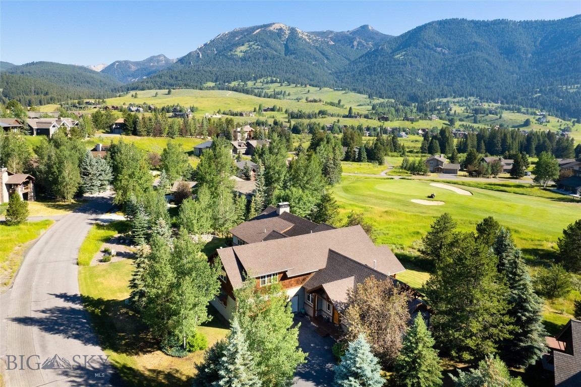A distinctive Meadow Village offering, this 5-bedroom, 5.5-bathroom home encompasses +/- 5,469 square feet on a rare double-sized .551-acre lot created through the combination of two original homesites. Backing to open space and the Big Sky Golf Course, and within walking distance of Town Center, the property offers an uncommon combination of space, privacy, and convenience.

A substantial custom addition by Reed Smith Architects enhances the home with a spectacular vaulted great room, wet bar, billiards/flex room, guest suite, additional flex space, and wine room. High-quality finishes, three gas fireplaces, numerous private decks, and beautiful mountain and golf course views create an ideal setting for both everyday living and entertaining.

At approximately +/- $600 per square foot, this property represents exceptional value in today's Big Sky market. Opportunities to own a home of this size, quality, lot size, and location at this price point are increasingly difficult to find.

The seller is not testing the market with an aspirational price. The home has been positioned to stand out among competing offerings, creating a compelling opportunity for buyers seeking size, quality, location, and value in one package.

The home also offers proven rental income potential. Introduced to the rental market for the first time this winter, it generated strong revenue, helping offset ownership costs while preserving flexibility for personal use.

Just steps from Town Center's restaurants, shopping, events, and recreation, this property delivers an outstanding combination of walkability, views, space, and value.