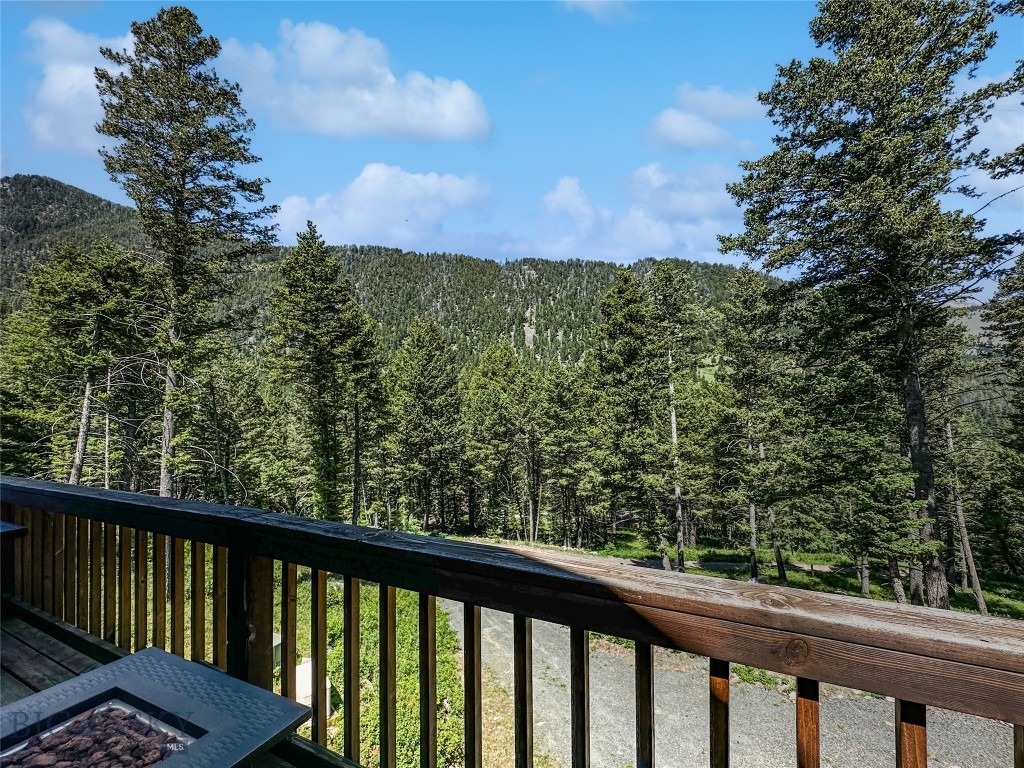 4 BED- 2 BATH cabin on TWO LOTS located in the trees close to National Forest Service and miles of back country trails for you to explore.  Be independent with your own well, septic, electric (yet has a propane generator if needed).  If you are ready to escape this chaotic world and find a perfect getaway high in the Tobacco Root Mountains then look no farther.    You could easily add a wood stove to add to your independent lifestyle.  Minutes from hunting in the National Forest. fish the South Boulder River or travel miles of trails to explore your back yard.  Be sure to bring your side by side or 4 wheeler.  This cabin is multi-level.  The open main floor has a nicely appointed kitchen with a dining table that looks out at the view.  2 bedrooms & a full bath are located on the main floor and there are an additional 2 bedrooms and bath in the daylighted walk-out basement.  The family room in the basement has a propane fireplace and the main floor has a pellet stove giving you different options for heat.  Want a bit more elbow room then hit the loft which could be a great office or TV room where you can enjoy the loft windows which let in a lot of natural light.  Most of the road is county maintained until "Upper Slope" road.  This cabin is offered with a second lot giving you future investment or building potential should you choose or just keep it for your solitude.  There are two outbuildings giving you the perfect option to store your toys.  Furniture could be purchased by private treaty making this your move in ready get-a-way just in time for summer.  In Montana you don't just buy a property.....you purchase a new lifestyle - choose yours today!!  Again......VA loan is assumable for qualified buyer (you do not have to be a Vet) at 2.625% interest but please understand this leaves a balance that you would need to either have cash or another source.  Call for details!