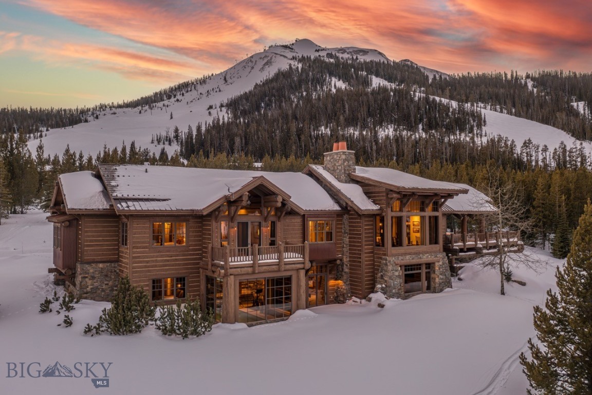 Located in the coveted Diamond Hitch neighborhood of Moonlight Basin, this exceptional custom mountain residence sits directly on the ski slopes and offers breathtaking Spanish Peaks views in Big Sky’s most prestigious community.
 
Designed for both refined mountain living and effortless entertaining, the home features a stunning great room with a wood-burning fireplace, soaring ceilings, and walls of glass that frame the dramatic alpine landscape. With six bedrooms, including the bunk room of every child’s dream, the residence comfortably accommodates multi-generational gatherings, guests, and private retreats alike.
 
The lower level is a destination in itself, offering a dynamic entertainment zone, game space, indoor pool, and a beautifully appointed bar — ideal for après-ski celebrations, summer evenings, and year-round hosting. Multiple outdoor living areas, including a covered deck, invite you to savor mountain air, sunsets over the Spanish Peaks, and the relaxed elegance of summer in Big Sky.
 
Offered furnished, this turnkey property allows immediate enjoyment with a level of quality, craftsmanship, and privacy rarely found.
 
Ownership provides the opportunity for Moonlight Basin membership, extending your lifestyle far beyond the home with access to an 18-hole Jack Nicklaus Signature Golf Course, a future par-3 course, the slopeside Moonlight Lodge, the vibrant LakeLodge, Ulery’s Lake Camp, miles of hiking, biking, and Nordic trails — and just moments away, the acclaimed One&Only Moonlight Basin Resort, celebrated for its exceptional dining, world-class spa experiences, and refined alpine hospitality.
 
Every detail of the residence reflects thoughtful craftsmanship and intentional design, blending timeless mountain architecture with modern comfort. Expansive sightlines, warm natural materials, and a carefully curated floor plan create a home that feels both grand and inviting. Whether enjoyed as a primary residence, a seasonal retreat, or a legacy mountain investment, this property offers enduring value in one of Big Sky’s most sought-after ski communities. This is mountain living at its finest — refined, adventurous, and unmistakably Moonlight.