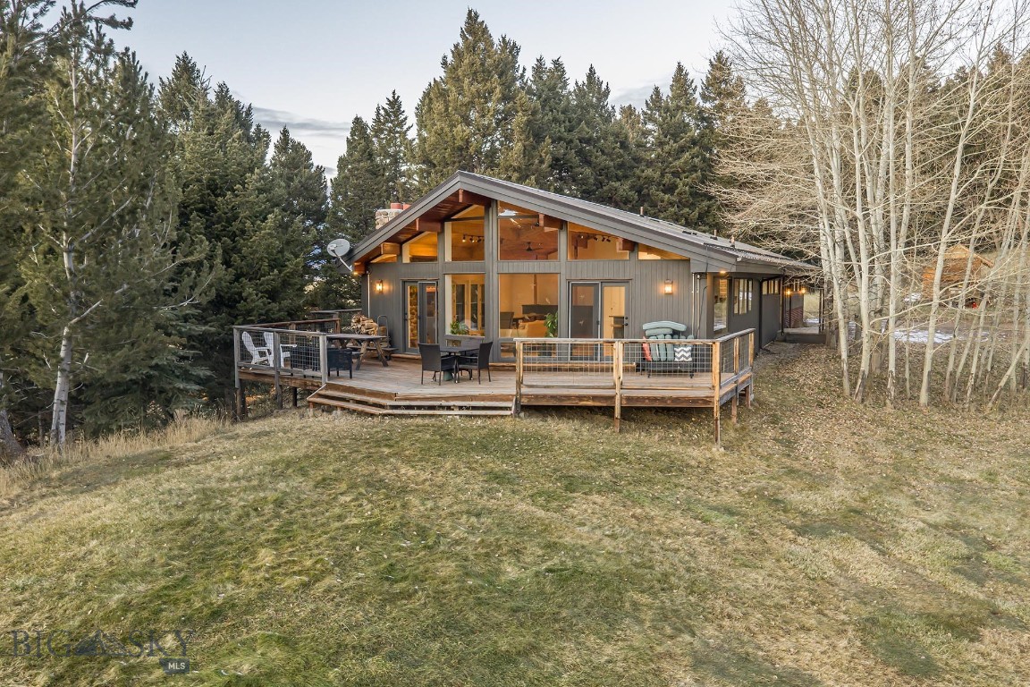 Nestled at the base of the iconic Bridger Mountain Range, Double G Montana offers a rare opportunity to own a 22± acre retreat at the end of a quiet road, blending luxury, nature, and privacy. This serene property boasts 690± feet adjacent to National Forest, granting direct access to thousands of acres for outdoor adventures. Surrounded by breathtaking views of the Gallatin Valley, you’ll experience unforgettable sunrises and sunsets from your very own mountain oasis.

The main residence, a 2,339± square-foot mountain modern home that has been remodeled, features three bedrooms, three bathrooms, and a seamless blend of modern design with natural elements. Vaulted ceilings and expansive windows flood the home with light, offering stunning views at every turn. A separate large garage/shop adds to the functionality and charm, allowing for ample storage equipment as well as a built-in commercial kitchen. For guests or additional living space, the detached 900± square-foot guest home designed by Intrinsik Architecture in Bozeman, Montana, provides one bedroom and one bathroom, ensuring comfort and privacy tucked along the property’s hillside, including a spacious wood deck and a patio area for enjoying time with family.

The property is a haven for wildlife, with frequent sightings of whitetail deer, bears, and various birds, including turkeys, alongside occasional visits from pronghorn. Its diverse landscape of rolling aspen hills, evergreen forests, and open meadows provides an ideal habitat for these animals. The natural surroundings also create endless opportunities for outdoor recreation, including hiking, biking, and cross-country skiing, making it a paradise for nature lovers and adventure enthusiasts alike.

Conveniently located just 20± minutes north of main street Bozeman and the Bozeman Yellowstone International Airport, Double G Montana is also within easy reach of Bridger Bowl Ski Area, 40± minutes, and Big Sky Resort, about 1 hour, 20± minutes. Whether you seek a peaceful retreat or an adventure-filled lifestyle, this property offers the best Montana living.