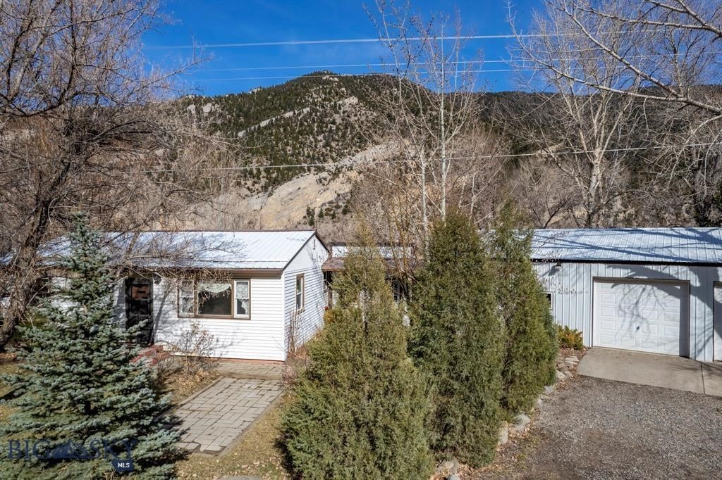 Why go on vacation when you can own it! 7.449 acres of playground. Grab your fishing rod, gear, toys and walk or ride down to your riverfront access to the Yellowstone! This sweet 2 bed 1 bath home comes with an oversized insulated garage with large shop space. Seasonal enclosed porch to enjoy the summer days and nights. Great yard with mature landscaping. Opportunities like this are rare. On the route to the amazing Yellowstone National Park, I90 to Bozeman, Big Sky, and a short drive down the valley to take in the outdoor concerts or enjoy either Chico Hot Springs or Sage Lodge.  During our 100 year flood in 2022, the lower part of the house took on water but the main part stayed dry. New insulation, sheet rock and flooring have been replaced down to the studs. THE RIVER IS CALLING AND THE FISH ARE BITING!!!