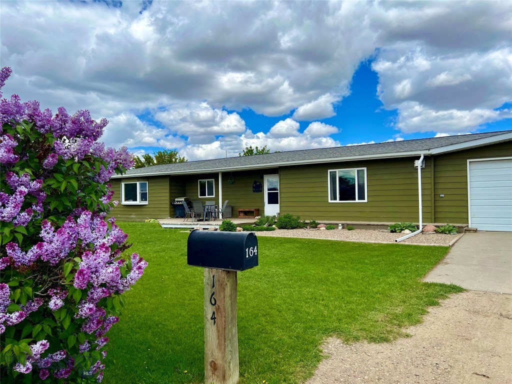 Nestled on 7.345 acres in the quiet community of Lothair, Montana, this unique property offers space, sustainability, and endless potential. Chemical-free for the past eight years, the land is thoughtfully set up for gardening with multiple established plots and the capacity to support a variety of animals, making it ideal for those seeking a self-sufficient lifestyle. The 2,640-square-foot home is well-maintained and updated, featuring four bedrooms, two full bathrooms, and two inviting living rooms—one upstairs and one downstairs—perfect for both gathering and relaxing. A gas fireplace adds warmth and charm, while the custom handmade kitchen island with shelving provides seating for up to 12, creating a true heart of the home. The spanning backyard is equipped with a sprinkler system, offering convenience and lush green space. Located in north-central Montana, recreational opportunities such as hunting, fishing, hiking, and exploring the wide-open prairies and nearby Sweet Grass Hills are all within reach. Less than 5 miles from the property is Willow Creek boat access to take advantage of fishing and playing on the water at Lake Elwell! Whether you envision a hobby farm, a family retreat, or a productive homestead, this property provides the flexibility to bring your vision to life.