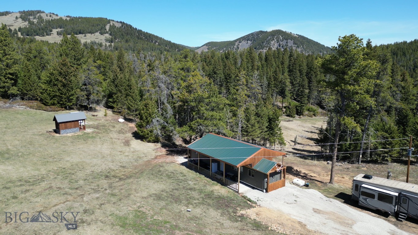 Tucked into the rugged beauty of the Judith Mountains, this acreage offers a rare opportunity to own fully functional hunting land and recreational property in the highly sought-after Game Management Unit 412. Positioned within over 420,000 acres of isolated mountain ranges, this property sits in prime wildlife habitat featuring Douglas-fir, lodgepole pine, and cottonwood—supporting elk, deer, bear, moose, and mountain lions.

The terrain offers a desirable mix of timbered slopes and open clearings, creating ideal bedding cover and feeding zones for big game. Water is a standout feature here, with a man made pond and Maiden Creek running through the property, an uncommon advantage in this region to draw in wildlife.

Unlike many properties, this parcel is already equipped with power, septic, and water available for domestic use, significantly increasing its usability and long-term value. Access is secure and convenient via a gravel road and gated entrance. Improvements include a 2-bedroom, 1-bath trailer with a storm-proof cover, allowing for year-round protection and a shaded porch space to enjoy the landscape. Keep all your equipment in the storage shed and 2 conexes!

Steeped in Montana history, these parcels were once mining claims dating back to the early 1900s, inactive since before World War II. Today, the land offers privacy, recreation, and investment potential. Whether you're seeking a hunting basecamp, mountain retreat, or build-ready rural property, this land is ready to use.

Property Highlights


Located in GMU 412 – premier hunting district
Elk, deer, bear, moose, and mountain lion habitat
Maiden Creek 
Power, septic, and domestic water already in place
Gravel road access with gated entry
2 bed / 1 bath trailer with storm protection structure
Timber + open terrain mix for hunting and recreation
Historic former mining claims
Ideal hunting basecamp or buildable land