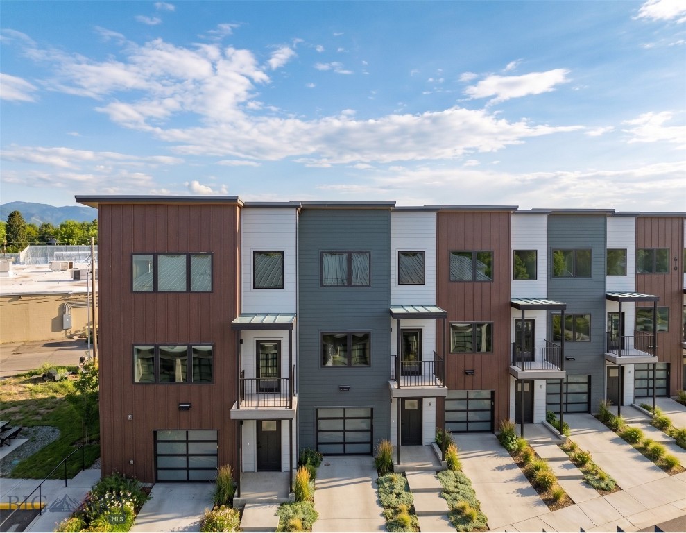 Introducing The Lofts on Beall, a newly constructed 11-unit condo development offering high-end, modern design and eco-conscious living just one mile from Historic Downtown Bozeman and Main Street. 1610 W Beall Unit C is a premier three-level, middle-unit residence with sweeping views of the Bridger Mountains and beautiful, light-filled spaces. With 3 bedrooms, 2.5 bathrooms, and a dedicated den, the layout offers flexibility for an office or fitness space, a second living room or guest space. The spacious main-level is designed to maximize light and flow, with expansive windows and high ceilings. The kitchen features upgraded custom cabinetry, quartz countertops, and Café appliances, blending elevated design with everyday functionality. A modern aesthetic, functional flow and high-end materials are designed for daily living and entertaining. A private second-floor balcony extends the living area outdoors, perfect for enjoying the Mountain views. The primary bedroom features a large ensuite bath with a tiled shower and dual vanities. Two additional bedrooms and a second full bathroom with high-end fixtures and finishes provide space for family and guests. A heated garage and dedicated laundry room offer ample storage. Defined by contemporary design, elevated finishes, eco-conscious construction, The Lofts on Beall introduce a brand-new condo offering to the Bozeman market. Low-maintenance ownership and lock-and-leave convenience support second-home use, investment potential, or simplified full-time living. Combined with an unbeatable location just one mile from Downtown Bozeman, the Lofts on Beall stand apart for both finish quality and proximity. Reach out today for a private showing!