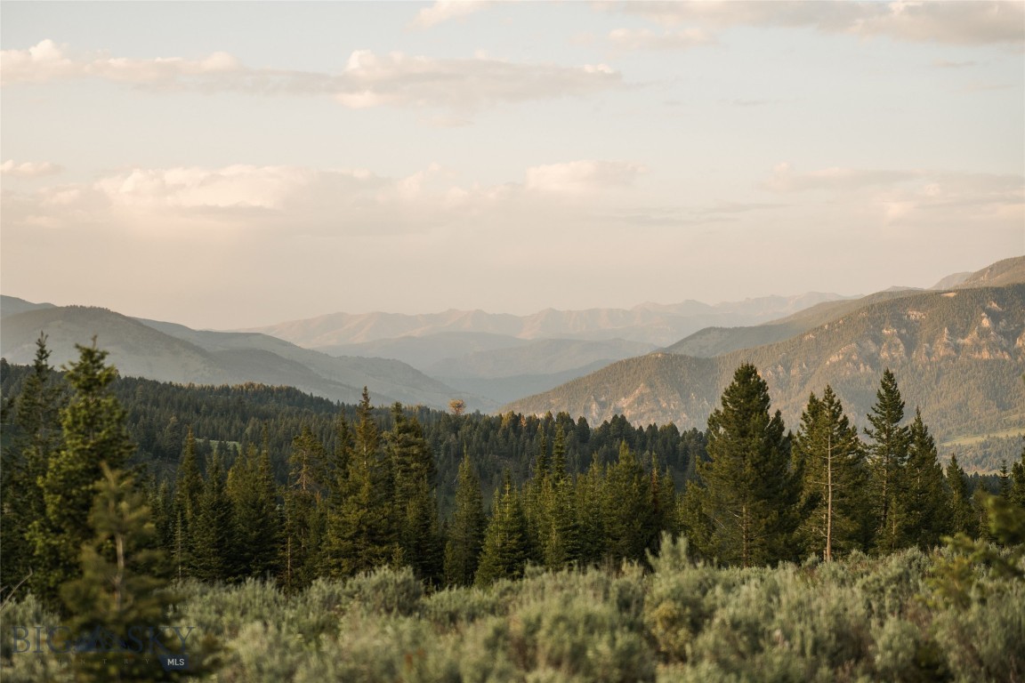 Exceptional 20-Acre Homesite in Big EZ & Spanish Peaks Mountain Club — Iconic Views, Privacy & Premier Club Access.

Set within one of Big Sky’s most exclusive gated communities, this extraordinary 20-acre parcel showcases sweeping southern exposure and dramatic mountain vistas stretching toward Yellowstone National Park. The setting offers a rare combination of expansive scenery, tranquility, and enduring privacy.

Located in the coveted Big EZ neighborhood, the property includes access to approximately 160 acres of deeded open space, peaceful trout ponds, and direct access to Gallatin National Forest lands—creating a private gateway to hiking, wildlife viewing, and backcountry recreation right from your doorstep.

The sloping terrain provides an ideal building envelope for a legacy mountain estate, allowing for architectural flexibility while preserving sightlines and seclusion. It’s a setting that balances true acreage privacy with the prestige and community of one of Big Sky’s most tightly held enclaves.

This property also offers the opportunity to apply for a Charter Golf Membership at the Spanish Peaks Mountain Club, subject to Club approval, deposit, and applicable dues and fees. Membership is separate from Big EZ HOA obligations and must be secured prior to closing. Approval is not guaranteed.

Combining natural beauty, recreational access, gated security, and optional world-class Club amenities, this offering represents one of the most compelling large-acre homesite opportunities currently available in Big Sky.

Photos include the property, surrounding landscape, scenic approach, nearby trout ponds, and adjacent wilderness areas.

Listing Broker is a member of the ownership LLC.