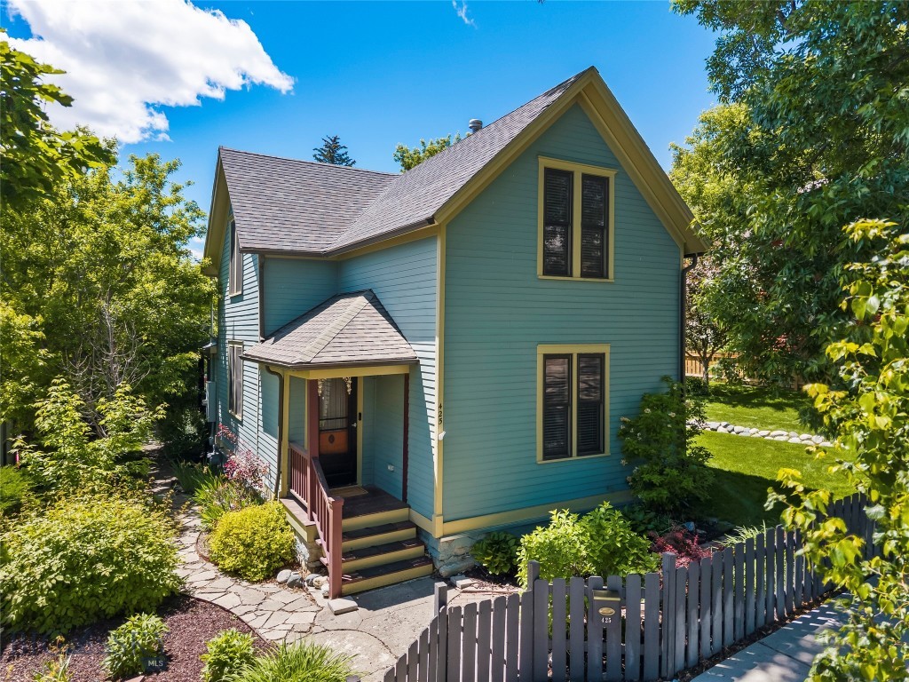 Step into a piece of Livingston history with this charming 4 Bedroom, 2 Bath home. Situated on a quiet side street just a few blocks from downtown Livingston, this beautifully maintained home is among the earliest constructed houses in the original Livingston townsite. Filled with character and timeless appeal, this home offers the warmth and craftsmanship that simply can't be replicated, complemented by tasteful modern updates that enhance comfort and convenience. Out back, an impeccably landscaped yard with a plethora of plants and flowers provides a peaceful retreat with plenty of space to relax or entertain, and an underground water sprinkler system ensures that the yard stays green and lush throughout the summer. To the rear of the property, a two-car garage provides space for parking, storage, or even a workshop. This is more than just a house, and opportunities to own a home with this much story and charm don't come along often.