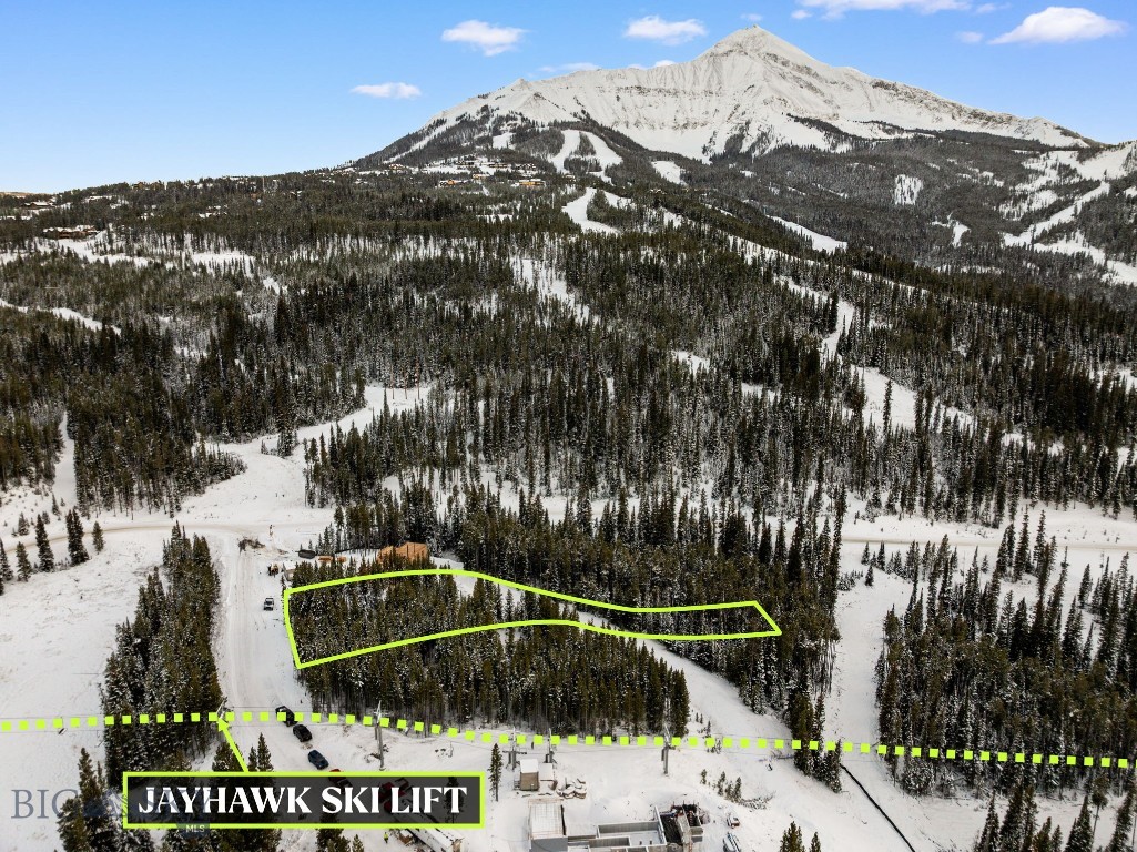 This exceptional 1-acre Moonlight Basin homesite combines direct ski access, dramatic mountain views, privacy and unparalleled proximity to Big Sky’s premier amenities. Positioned on a quiet street with only four homesites, the property offers a peaceful, low-traffic setting just steps from the Jayhawk ski lift, providing unmatched convenience to both Moonlight Basin and Big Sky Resort. Panoramic views of Lone Mountain, Fan Peak, and the Spanish Peaks anchor the landscape, with protected open space directly in front. A serene meadow and seasonal stream enhance the natural setting, attract wildlife, and preserve long-term view corridors. From the Jayhawk ski lift, you can ride directly to the Madison Base Area, home to the brand-new heated 8-seat bubble chairlift, dining, ski school, rentals, and family-friendly terrain. In the opposite direction, the lift brings you to LakeLodge, Moonlight’s newest amenity center featuring a heated pool, hot tubs, fitness center, golf simulator, indoor climbing wall, multi-sport court, and restaurant. The homesite is also just minutes from the newly opened One&Only Hotel offering exceptional dining, a luxury spa, and world-class hospitality. Additional advantages of the land include approved architectural plans through the Moonlight Basin Design Review Board and a completed geotechnical report—allowing you to begin the build process with confidence and efficiency. 
With direct access to the Jayhawk ski lift, proximity to world-class amenities, and a private and quiet street setting, this Moonlight Basin homesite is the ideal foundation for your modern mountain retreat.
