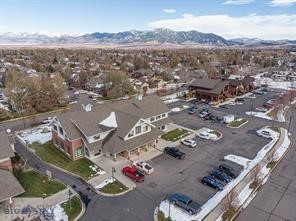 This unit offers exceptional flexibility and value in a 1,421 sq ft suite thoughtfully designed for wellness practitioners. The space features seven spacious treatment or office rooms, several of which are plumbed for sinks, plus a dedicated laundry closet with washer/dryer hookups and generous storage. Three of the seven offices enjoy abundant natural light and north-facing mountain views.

Additional amenities include a functional kitchenette, air conditioning, a dedicated waiting area, common-area bathrooms, elevator access to the second floor, over 25 on-site parking spaces, and plentiful off-street parking for clients and guests.

Flexible leasing arrangements make Unit E ideal for owner-users or investors seeking reliable returns. The building’s HOA is in excellent standing and has recently completed significant exterior upgrades. A recent comparable unit sale at a notably higher price further highlights this as a compelling equity opportunity.

Buyers also have the unique option to acquire adjacent, legally distinct spaces: Unit F, 1,633 sq ft, and Unit G, 1,678 sq ft, creating expanded possibilities for growth, income, or investment for a total of 4,732 overall SQFT.  This property is presently being utilized as a wellness center, and this is an amazing opportunity to continue with that vision or create your own unique opportunity.  

Seller is a Licensed Broker in the State of Montana.