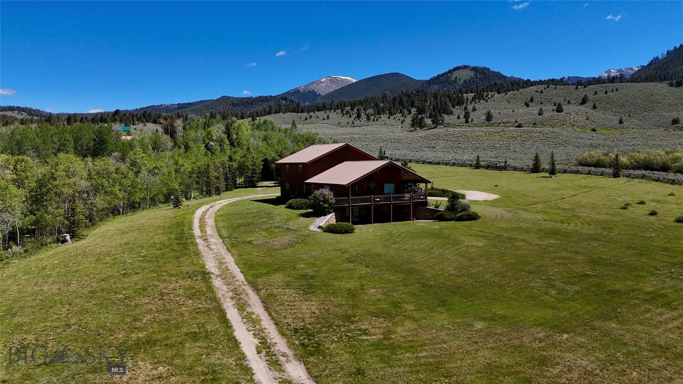 Nestled in the heart of Polaris, Montana, this stunning cabin-style home offers the perfect blend of comfort, scenery, and year-round recreation. Situated on 12.34 acres and surrounded by public land, the property provides unmatched access to outdoor adventure, including hiking, snowmobiling, and endless exploration right out your door. Located near Elkhorn Hot Springs and just minutes from Maverick Mountain Ski Area, this is a true mountain retreat.
The main level features expansive windows that frame breathtaking views of Maverick Mountain Ski Hill, filling the home with natural light. This floor includes a spacious bedroom and a dedicated hot tub room—ideal for unwinding after a day on the slopes. The second level offers two additional bedrooms, a full bathroom, and a comfortable living area, perfect for family or guests.
The walkout basement adds incredible flexibility with a kitchen, living area, two bonus rooms, a full bathroom, and a mechanical room—ideal for extended guests or additional living space. A large shop provides ample room for equipment, vehicles, or hobbies.
Whether you’re seeking a vacation getaway, investment opportunity, or your dream mountain home, this exceptional property delivers privacy, views, and access to Montana’s best outdoor recreation.