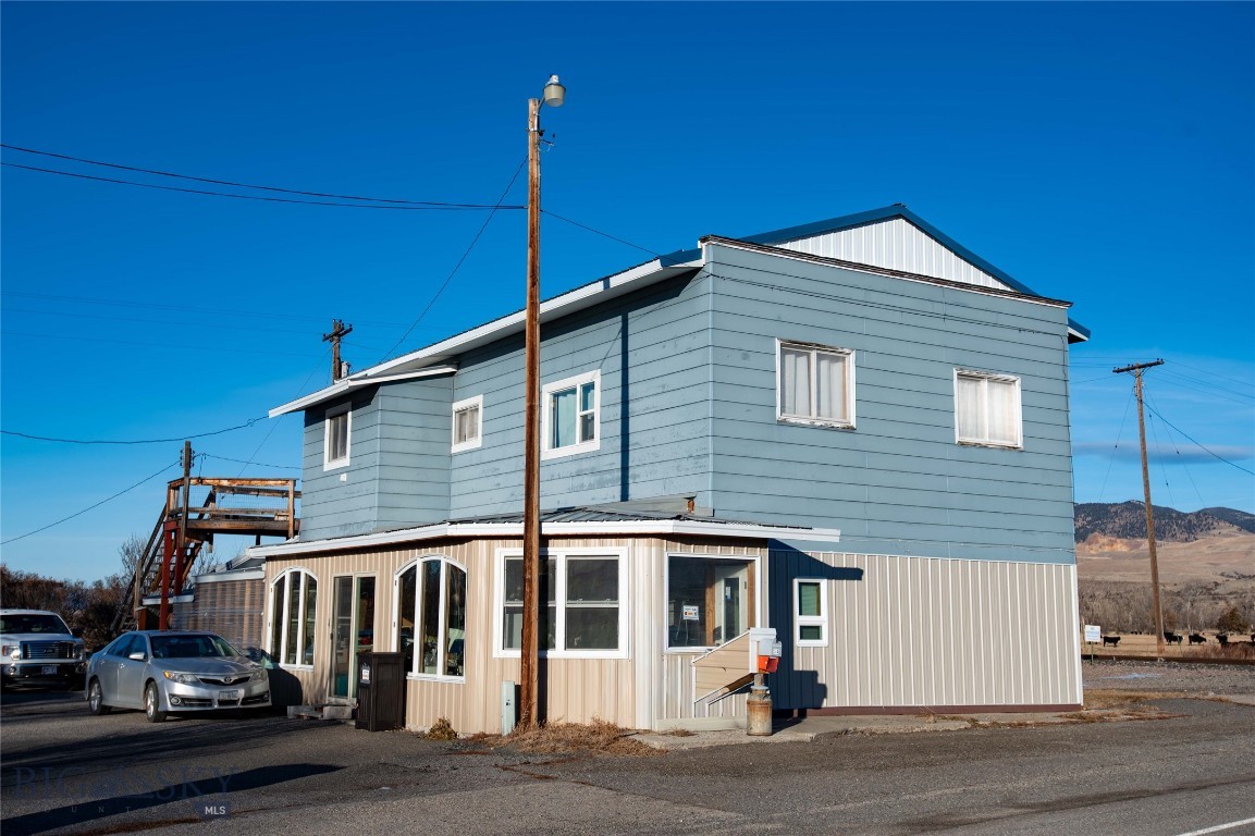 An exciting investment opportunity is available in the charming town of Cardwell, MT. Located close to Butte and less than an hour from Bozeman along I-90, this property features two units. The upper level comes equipped with newer appliances, while the main level unit was completely remodeled in 2018, showcasing updated flooring and modern appliances. The upper unit also boasts a large deck with stunning views of the Tobacco Root Mountains towards Butte and Pipestone. Both units have separate electric meters, along with a third meter for the shared well; the owner bills neighboring properties for their respective shares of the electricity used for the well. A large pellet stove efficiently heats both units. Additionally, there is a common area with an additional bathroom. Included with the property is a detached two-car garage with an opener, as well as a 20x22 shop. The landscape is enhanced by fruit trees and perennial plants. Don’t miss out!