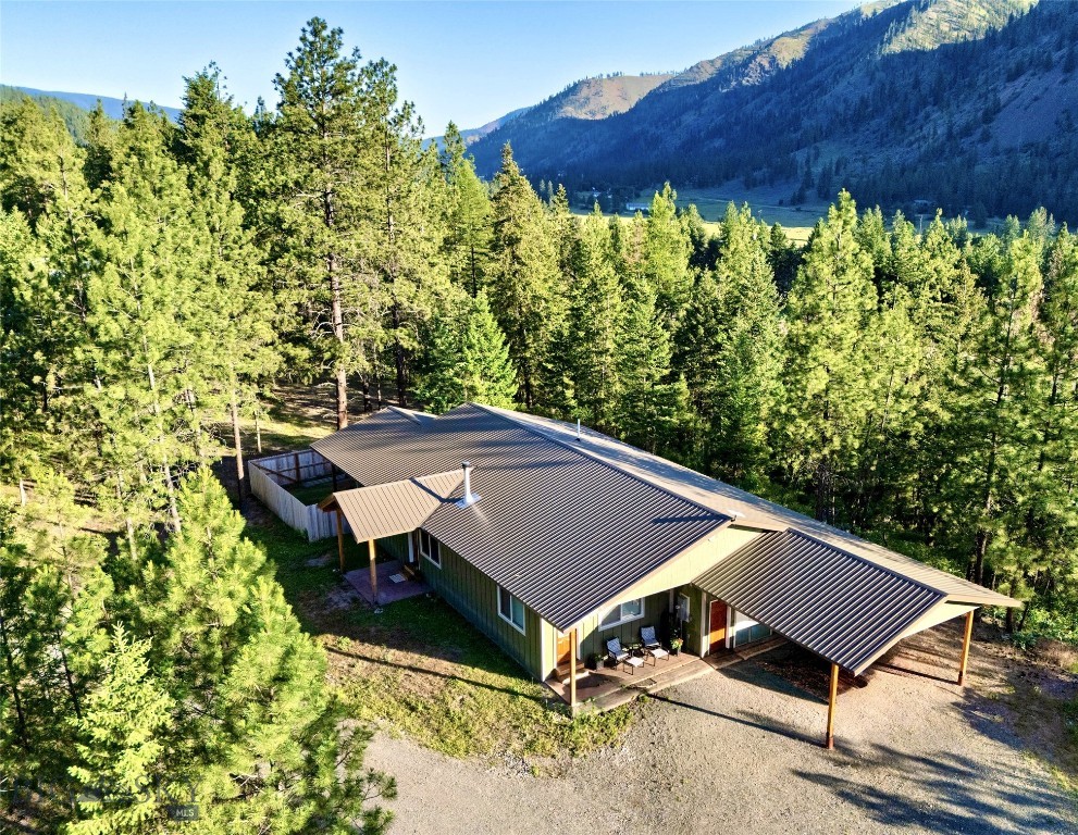 Discover the perfect blend of privacy, comfort, and opportunity with this beautifully finished 3-bedroom, 3-bath home situated on 2.3 wooded acres. Tucked among mature trees, this property offers a peaceful, secluded setting while remaining just minutes from downtown Superior and providing easy access to Interstate 90 for convenient commuting. Inside, you’ll find quality craftsmanship throughout, featuring granite countertops, warm tongue-and-groove wood walls, and durable luxury vinyl plank flooring that combines style with low-maintenance living. The thoughtfully designed layout creates a welcoming atmosphere, ideal for both everyday living and entertaining. Adding exceptional value is the attached apartment, offering excellent potential for rental income, multi-generational living, or guest accommodations. Whether you’re looking to offset your mortgage, invest in additional revenue, or simply enjoy extra space, this versatile feature provides endless possibilities. Enjoy the serenity of Montana living with room to roam, abundant privacy, and the convenience of nearby amenities. Properties offering this combination of acreage, quality finishes, and income-producing potential are rare—don’t miss your opportunity to make this unique property your own.