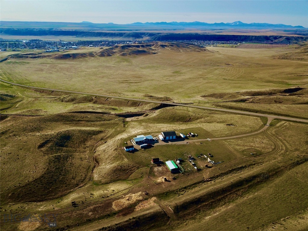 Overlooking the picturesque valley carved out by the mighty Missouri River, marking the birthplace of Montana, this meticulously maintained 94.1-acre property offers a unique blend of rustic charm and modern comfort. The residence features a 1,848-square-foot manufactured home with three bedrooms and two bathrooms, situated on a solid poured concrete foundation with double-wall insulated skirting for enhanced energy efficiency. Designed to complement the cowboy lifestyle, the property includes well-appointed corrals, a barn, and pens, including a designated maternity pen. The primary bedroom boasts a spacious walk-in closet and an ensuite bathroom equipped with a soothing soaking tub, ideal for unwinding after a day spent tending to livestock. Step out onto the covered back porch to enjoy breathtaking views of the Highwood Mountains and the stunning landscape that surrounds you. Thoughtful landscaping, concrete sidewalks, and functional outbuildings enhance the property's appeal. The expansive 40’ x 48’ shop features three stalls, providing ample space for equipment, recreational vehicles, or additional storage. In addition, bring your creative business ideas to run out of the shop! This property is a rare find, combining modern amenities with a warm, inviting atmosphere that you will be proud to call home. The entire property has been well planned and constructed. With vast open spaces, there are abundant opportunities for outdoor activities such as horseback riding, hiking, and exploring the natural beauty that envelops you. The nearby Missouri River adds an adventurous element, perfect for fishing or simply relishing the serene waters. Fort Benton is a two-minute drive while Great Falls is just 45 minutes making a commute convenient. Schedule a showing to experience the exceptional qualities this property has to offer!