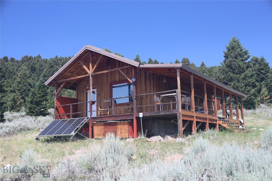 Lazy moose cabin is located on 10 treed acres high in the Gravelly Mountains.  This off grid cabin is fully wired (grounded neutral system) and runs from a 2200 Watt system (Solar, Generator, with battery back up).  The open living room, dining area and kitchen has a vaulted ceiling and access onto a covered wrap around porch that takes in those beautiful mountain views.  The upgraded bathroom includes a tiled shower (hot water in 16 minutes) and an RV Flush toilet.  Kitchen has a propane range & energy efficient refrigerator.  The Cabin has a wood burning fireplace (though current owner has never used it) and a propane wall heater.  The bedroom on the main floor has propane lanterns for function and ambiance.  You can plug in to the world via fiber optics or stay unplugged and enjoy the sights, sounds & smells of the surrounding forest and watch your neighbors: deer, elk, moose, antelope or the occassional mountain lion & bear.  Located just 1.1 miles from National Forest and just a short jaunt down the hill to trout stocked Haypress Lakes.  Bring your horses, your side by sides, or a good book.....in Montana you don't just buy a property you purchase a new lifestyle.  Cabin is offered turn-key complete as it is currently used as a short term rental - 26 FIVE STAR REVIEWS from last two years alone!