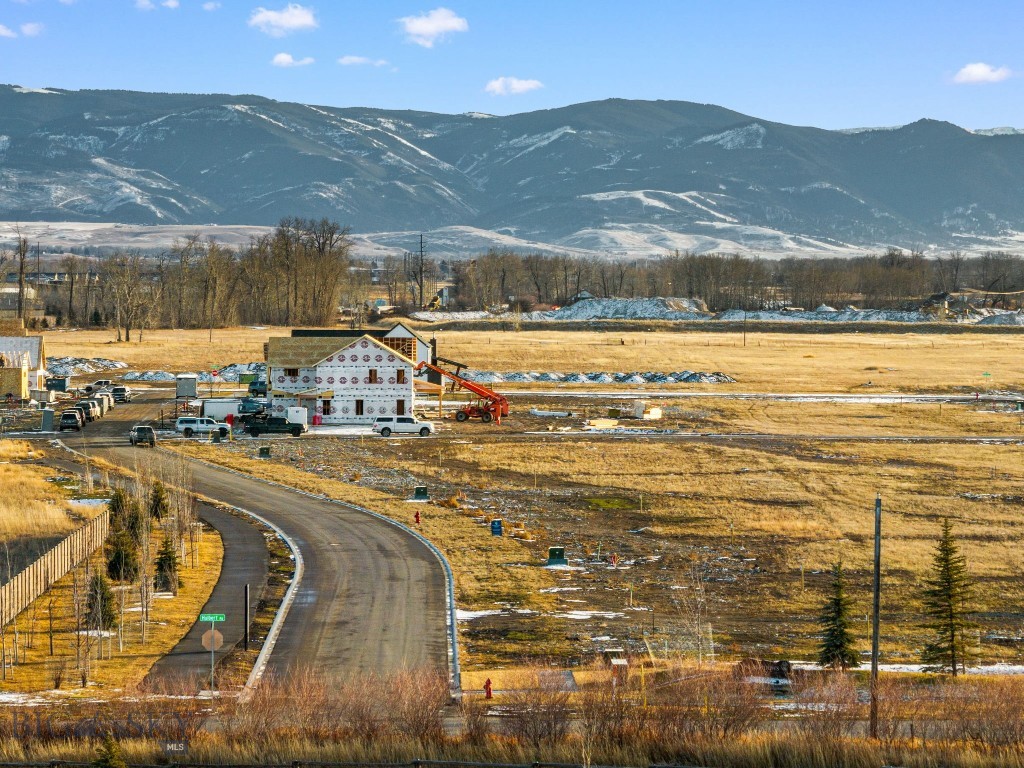 Build your dream home on Bozeman’s highly sought-after west side, where expansive views and endless possibilities come together. Situated on just under a half acre lot, this property offers a rare opportunity to design a custom residence surrounded by sweeping panoramic vistas of the Gallatin, Madison, and Bridger Mountain Ranges, providing a breathtaking backdrop that evolves beautifully with every season. With generous space to thoughtfully plan your home, the lot allows for a wide range of building possibilities. Imagine expansive windows capturing mountain views, outdoor living spaces designed for entertaining, and room to create a property that truly reflects your lifestyle. Whether building a primary residence, second home, or a well-positioned spec project, this property provides the flexibility and setting to bring your vision to life. Perfectly located for both adventure and convenience, the property offers easy access to Big Sky and the Gallatin Canyon, placing world-class skiing, fly fishing, hiking, and mountain biking just a short drive away. Downtown Bozeman is only minutes from your doorstep, offering vibrant dining, boutique shopping, local events, and everyday amenities. The west side continues to grow in popularity thanks to its accessibility, open surroundings, and ideal balance of neighborhood living and Montana’s wide-open feel. Opportunities to build in a location that combines scenery, convenience, and long-term desirability are becoming increasingly rare. Don’t miss your chance to create your own piece of Montana and build a home perfectly suited to the way you want to live.