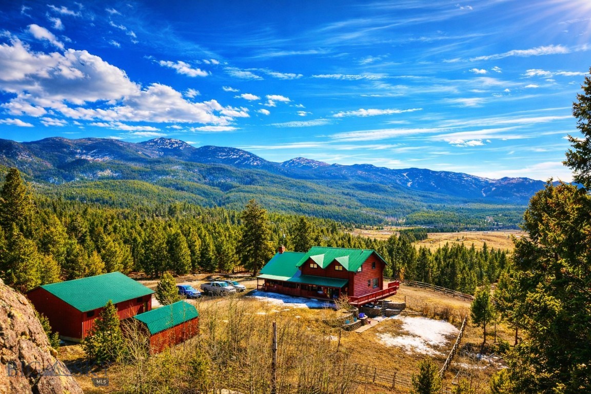 Nestled in Southwest Montana, 3 Bears Wildlife Sanctuary offers 70± acres of pristine land minutes from Butte and surrounded by expansive U.S. Forest Service land. This 3,610 sq ft log home features soaring ceilings, exposed beams, a stone fireplace, and expansive windows capturing breathtaking mountain views. Wraparound decks provide seamless indoor-outdoor living. 

Abundant wildlife, privacy, and versatile terrain create a true Montana retreat—ideal for recreation or year-round living in the sought-after Elk Park area.

Wildlife is abundant—elk, deer, and native species frequently traverse the landscape—creating a truly sanctuary-like setting. Each season paints the property with its own character, from vibrant green summers to snow-covered winter vistas, making this a remarkable year-round escape.

Located in the sought-after Elk Park area, 3 Bears Wildlife Sanctuary offers the perfect balance of seclusion and convenience, with easy access to the amenities, dining, and rich history of Butte—while remaining immersed in a peaceful, rural setting.
