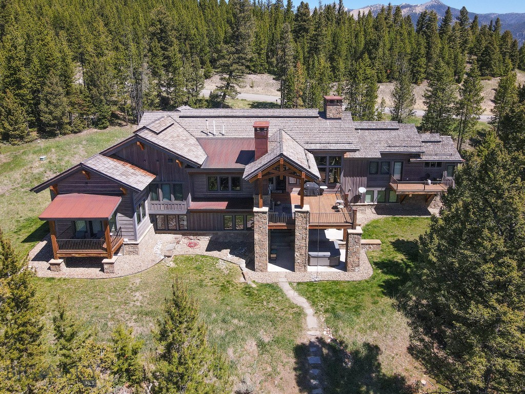 Nestled on two private acres bordering open space in the Ranch Neighborhood of Spanish Peaks Mountain Club, 34 Old Barn Road offers an exceptional mountain retreat where rustic elegance meets comfort. Surrounded by sweeping mountain views, this five-bedroom, four-and-a-half-bath residence embodies the very best of Big Sky.
Thoughtfully designed for both intimate family gatherings and sophisticated entertaining, the home features warm, inviting interiors highlighted by radiant floor heating throughout, energy-efficient geothermal systems, two interior fireplaces, and a climate-controlled 80-bottle wine cellar. Expansive living spaces and well-appointed guest accommodations create a seamless balance of luxury and livability.
Outdoor living is equally compelling, with generous gathering areas centered around a wood-burning fireplace and complemented by electric infrared heaters, allowing for year-round enjoyment of Montana's breathtaking scenery. Whether savoring a quiet morning coffee or hosting guests beneath the stars, the setting is both peaceful and unforgettable.
Ownership includes access to Spanish Peaks Mountain Club. During the winter season, enjoy convenient ski-in/ski-out access via a short drive to the Clubhouse. In the warmer months, members enjoy an unparalleled lifestyle featuring championship golf on the Tom Weiskopf-designed course, the newly opened 10-hole Par-3 course, world-class hiking and biking trails, blue-ribbon fishing, and a vibrant club atmosphere.
The Spanish Peaks Clubhouse serves as the social heart of the community, offering private dining, a full-service bar, outdoor terraces, fitness facilities, a professional golf shop, and private locker rooms—all delivered with the exceptional service and exclusivity that define Spanish Peaks Mountain Club.
A rare offering in one of Big Sky's most prestigious private communities, 34 Old Barn Road presents an extraordinary opportunity to enjoy mountain luxury, privacy, and adventure in equal measure.
Spanish Peaks Mountain Club Membership is required. A Golf or Social Membership is associated with this offering.
