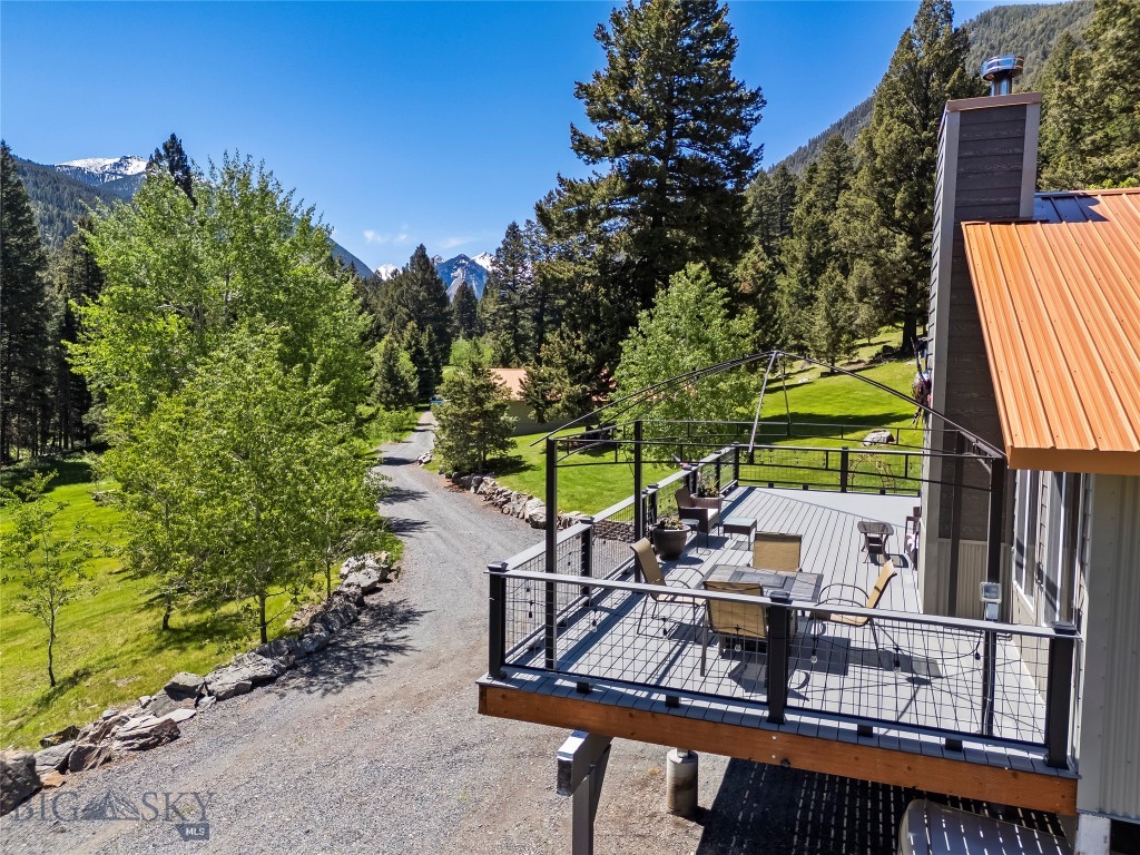 Over the river and through the woods, to the mountain house we go! Welcome to the community of Mammoth, where time stands still, and the birds fly high as the river runs by. The Tobacco Root Mountains are home to some of Montana's Best Hiking Trails, Fishable Alpine Lakes, and Incredible Sunrise Summits. Outdoor Enthusiast from around the country frequent this area as it is known to have an Abundant Wildlife Population. With miles of forest service roads that continue to the tree line and beyond, the opportunity to explore truly feels like its right out your back door. If you have been looking for a piece of paradise to get away from the crowds, this property has all the peace & quiet you could ask for, and More! This cabin offers 2 Bedrooms on the main floor with bathrooms conveniently located for each. Vaulted Ceilings and oversized windows bring the sights and sounds of  the forest into your day while you enjoy natural light from space to space throughout the home. The Lower Level offers a 3/4 bath plus additional an (Nonconforming) Bedroom, and room to entertain with a bar, pool table and large living room with high ceilings. Get your next project off the ground in the garage workspace, and adjacent craft room. Not to mention this home is being sold fully furnished with high end comfortable furniture, (minus personal items). Looking for a space to tinker and store your sleds and off road vehicles? The 40'x60' Heated Shop has room for all that and your neighbors tractor! While he fixes and fish's the day away, make time for yourself and relax in the jetted jacuzzi tub as the animals meander through the trees right outside your window. Take a walk through the forest down to the South Boulder River, somewhere along the 300+ feet of frontage, you're sure to find the perfect sunny spot for those Adirondack chairs amongst the pines. From the moment you set foot in this place you realize that the Call of the Wild whisper's "Adventure Is Out There!". Come see why this home, that sits between the End of the Road, and the Beginning of thousands of acres of National Forest is the great escape you have been searching for... "The mountains are calling, and I must go!"