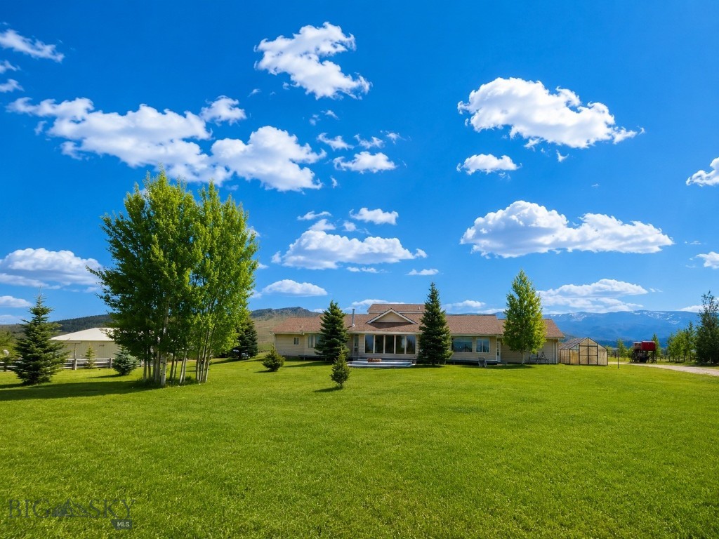 Whether you are looking for a year around home or a place to rope, ride or train horses during the summer months, this place may be calling your name.  With "end of the road" privacy backed up to State, BLM & just a short ride to FS, it comes with a 60 x 100 heated & insulated indoor riding arena & a large outdoor arena along with a round pen.  Pastures have had sage removed and are fenced and cross fenced. The home is designed with a private suite on each end & common area in the center. Complete with 3 bedrooms, + an office that could be used as an extra bedroom, 4 bathrooms, 3 cozy woodstoves & large window that capture outstanding views from every room.  The screened in porch is perfect for lunches or naps. Entertain on the large deck with a firepit.  Just 3+ miles to Wisdom, MT and near two awesome ski hills, 3 hot springs and great restaurants.  Wisdom is a small but welcoming community.  The views from this property are beautiful, expansive and 360 degrees.  There is a small public airport for small aircraft just a few miles away.  Five large paddocks are attached to box stalls.  Barn is complete with tack room, hay storage, equipment storage, box stalls and riding arena.  Property is surrounded by  a conservation easement on 2 sides and State on one.  It is an easy ride to 10+ high mountain lakes with great fishing, including Sand Lake, Lily Lake, Odell Lake, Bobcat Lake and Lake of the Woods plus more. I think you will agree, this is a one in a million property.