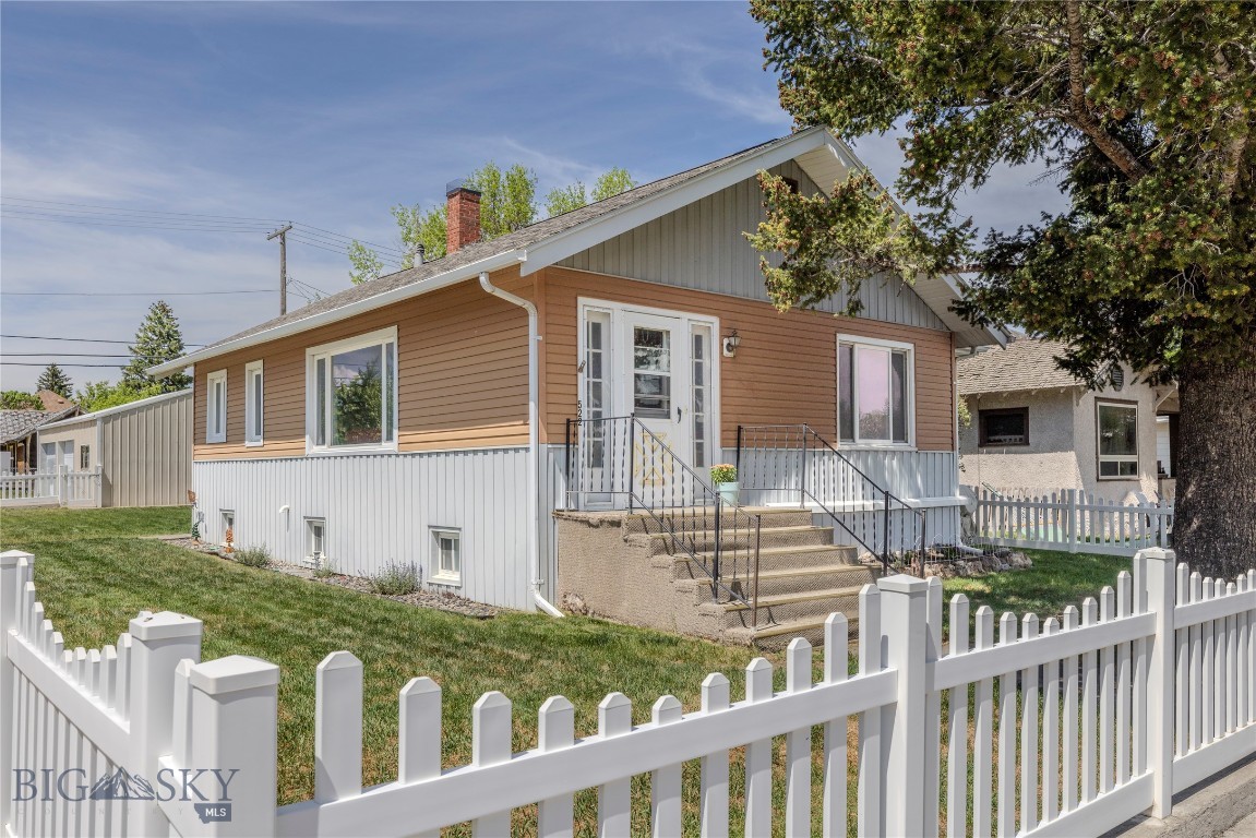 The West Front Cottage & Shop brings together cottage charm, Montana views, and hard-to-find garage/shop space in town. The main level has a bright living room, dining area, kitchen, two bedrooms, and a full bath, with natural light and an easy, comfortable feel. Downstairs, the lower level adds a second bath, laundry, storage, a non-conforming bedroom, and flexible finished space for a family room, hobbies, work, guests, or gear. Outside, there is mature shade, a fenced yard, off-street parking, and a large detached garage/workshop with room for vehicles, tools, toys, and Montana gear. Across the street, the railroad corridor helps keep the mountain view open, giving the property a setting that feels spacious for an in-town Livingston location. Trane central A/C, gas forced-air heat, and city services add everyday convenience. Charming, practical, and easy to appreciate, this West Front home offers a nice mix of character, function, and views.