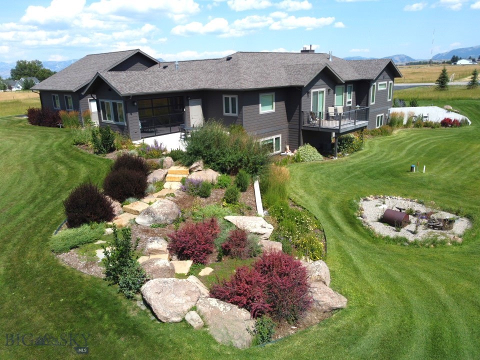 Discover the perfect blend of timeless charm and modern convenience in this stunning custom Craftsman-style home, nestled on three serene acres with a private well and septic. The layout is ideal for many living situations, boasting a well thought out main floor with all living essentials as well as an expansive primary suite. On the same level you'll find a cedar sided sunroom/hot tub room that is quite impressive, inviting Bozeman’s outdoors in. With 4 spacious bedrooms, 3 full bathrooms, an expansive living room with an additional family room downstairs, an extra room for storage, crafts, etc.. there's plenty of room for your imagination to roam free and make this house your dream home! Some of the custom finishes to highlight are: solid oak hardwood flooring, live edge granite counter tops, wood doors and trim, heated tiled flooring, and 9 foot ceilings. Step into the oversized 3 car garage (plumbed for a gas heater) and also enjoy the recently re-surfaced driveway for all your toys. If you're dreaming of lush gardens, a private retreat, or space for your horses, look no farther. With minimal zoning restrictions and covenants fit for rural Montana living, you have the incredible flexibility to customize your property to your heart's desire. Enjoy the open pasture with your horses and other pets. Enjoy breathtaking 360° Views: Wake up to panoramic vistas every morning, with stunning views in each direction, capturing the beauty of the Gallatin Valley. Close to Town: Enjoy the peace and privacy of country living, while still being just minutes away from shopping, dining, and all the conveniences of town life. Located in desirable Anderson School District. This is more than just a home—it's an opportunity to create the lifestyle you've always wanted. Don't miss out on this rare gem. Schedule your private tour today!