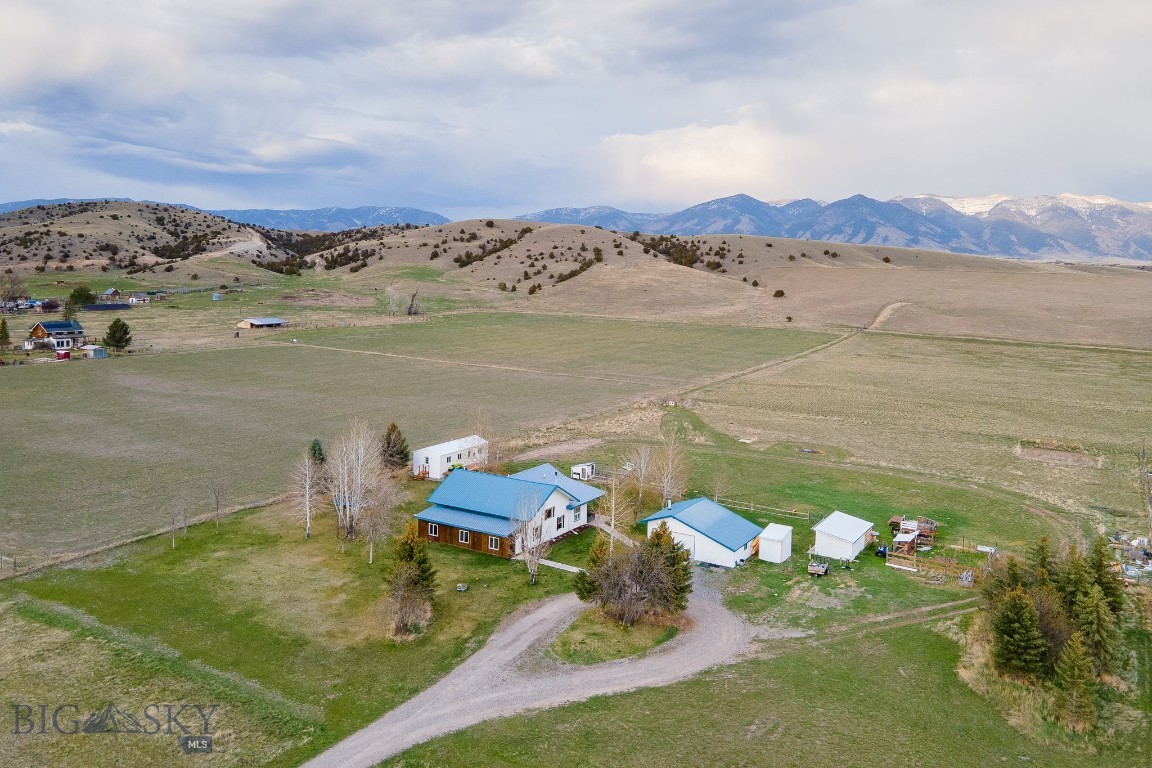Discover the perfect blend of space, flexibility, and Montana beauty with this exceptional property set on 4 acres of open land. With breathtaking, unobstructed views and located in the highly sought-after Manhattan School District, this property offers both freedom and convenience.

The main residence features 5 spacious bedrooms and 2.5 bathrooms, designed with an inviting open floor plan that’s perfect for gathering and everyday living. Hardwood floors enhance the main living spaces, adding warmth and timeless appeal. A cozy wood stove anchors the home, providing comfort during the winter months, while the durable metal roof offers long-term peace of mind.

Also on the property is a detached bonus space, offering incredible versatility. This area can be used as a private kids’ getaway or gaming room, additional guest accommodations, or even rented out on Airbnb for supplemental income.

Complementing the main home is a fully equipped ADU (Accessory Dwelling Unit), ideal for guests or rental income. This thoughtfully designed space includes 1 bedroom, 1 bathroom, a full kitchen, in-unit laundry, and a private deck to enjoy the peaceful surroundings.

Additional features include a detached two-car garage, a chicken coop for hobby farming or sustainable living, and expansive acreage offering endless possibilities.

Tucked away in a quiet and serene setting, this property is a rare opportunity to enjoy true Montana living with room to grow, gather, and thrive.