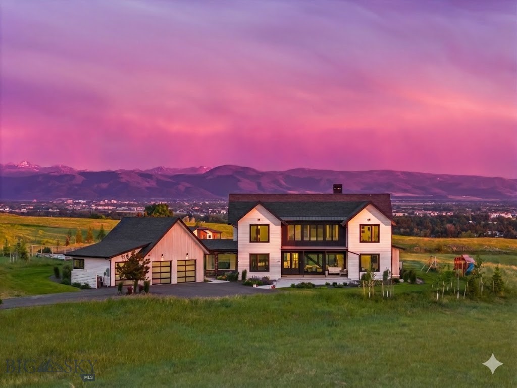 Perched atop the premier lot in Springhill Reserve, this stunning custom home captures some of the most breathtaking views in all of Bozeman. Set on 1.51 acres, the 4-bedroom, 3.5-bath, 3,577 sq ft residence was thoughtfully designed to blend luxury, functionality, and natural beauty. As you arrive via the tree-lined driveway, the panoramic views immediately impress.

Inside, a chef’s dream kitchen awaits, featuring high-end Thermador appliances, including a built-in 36” refrigerator and 18” freezer, dual dishwashers, a built-in coffee station, oven, speed oven, and a 36” range. A custom dumbwaiter makes transporting items to the spacious upstairs living area effortless, where a built-in bar and expansive family room offer the perfect setting for entertaining. Wine lovers will appreciate the striking 150+ bottle wine rack—both a storage solution and a conversation piece.

Throughout the home, 8-foot doors and high-end finishes reflect careful attention to detail. The lower-level living space boasts vaulted ceilings and a wood-burning fireplace with a gas-assist start, creating a warm and inviting atmosphere. Step through oversized glass doors onto the expansive south-facing patio, complete with a gas fireplace and sweeping views of the Gallatin Valley.

The front office enjoys uninterrupted views of the Bridger Mountains, ideal for a serene work-from-home setup or a private fitness space. Each bedroom features custom closets, blending elegance with practicality.

Outdoors, the property offers not only privacy and open space but also a dedicated, expansive fenced garden with raised beds. Perfect for seasonal plantings, or creating your own farm-to-table experience while taking in the surrounding mountain views.

Ideally located just 4 miles from downtown Bozeman and 5 miles from Yellowstone International Airport, this home offers both convenience and serenity. Springhill Reserve residents enjoy nearly three miles of private walking trails, a tranquil pond, and over 50 acres of open space—making this property an exceptional blend of comfort, lifestyle, and location.