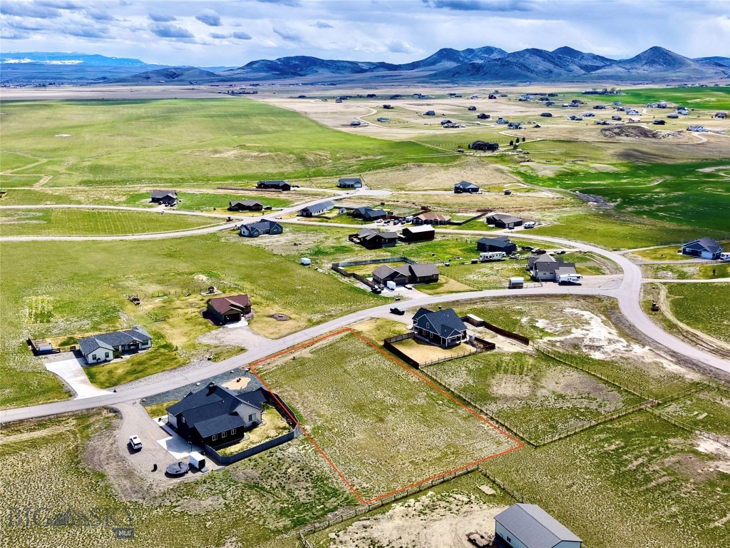 Lot 173 Western Larch Place is a level, build-ready 1.04-acre home site in The Village at Elk Ridge, a well-established subdivision eight miles from Three Forks, Montana. Power is already to the lot, legal access is in place via paved subdivision roads, and the groundwork of a quality community — covenants, maintained infrastructure, and shared amenities — is already in place. For a buyer with plans in hand, there is very little standing between this parcel and a shovel in the ground. The setting is the real story. From this lot, the horizon opens across the Gallatin Valley floor to four surrounding mountain ranges, with light and color shifting through every season. The subdivision itself is thoughtfully laid out with more than 25 acres of shared open space, a 6-acre park, a gazebo, barbecue areas, and basketball courts. Location is where the numbers work. The lot sits at the center of a triangle formed by three of Montana's most active markets: roughly 30 minutes to Bozeman, an hour to Helena, and just over an hour to Butte. Interstate 90 is minutes away. Yellowstone National Park is 90 minutes south; Bridger Bowl, the Madison, the Gallatin, and the Jefferson rivers are all within an easy drive. Three Forks itself, the historic site of the Missouri Headwaters and a small town with real staying power, offers day-to-day services, a 9-hole golf course, and steady growth tied to the broader Gallatin Valley corridor. For a buyer ready to build their Montana home, this is a straightforward lot at an accessible entry price in a region where lots like this have become increasingly hard to find under six figures. For an investor, it is a low-carry hold in a path-of-growth market anchored by Bozeman, one of the fastest-growing small metros in the country. The seller is motivated and open to a clean, reasonable offer.