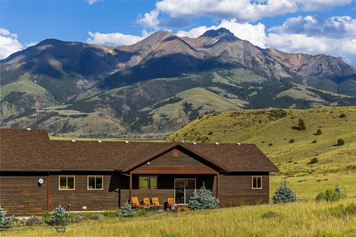 Some properties offer mountain views. This one lives in them. Tucked away on 25 remarkably private acres along Hidden Valley Road, this exceptional custom home was thoughtfully positioned to capture some of the most spectacular views in all of Paradise Valley. Emigrant Peak rises dramatically just beyond your windows, while sweeping 360-degree views stretch across the Absaroka and Gallatin mountain ranges with glimpses of the Yellowstone River below. Every sunrise feels like a private showing, and summer afternoons often end beneath brilliant Montana rainbows. Built in 2017 and meticulously maintained by its original owners, this single level home was designed around the landscape. Vaulted cedar plank ceilings and expansive windows frame the mountains like living artwork, while a floor-to-ceiling Montana moss rock fireplace anchors the open-concept great room. The kitchen features alder cabinetry, black stainless appliances, granite countertops, and a large island that naturally becomes the heart of every gathering. Circular-sawn hickory hardwood floors, solid alder doors and trim, and warm finishes create a timeless Montana feel. The two bedroom suites are thoughtfully separated for privacy, each with its own walk-in closet. The primary suite opens to a private deck with breathtaking mountain views to enjoy your morning coffee, and includes a spacious tiled bath with a walk-in shower. A generous laundry and mudroom offers plenty of space for boots, waders, skis, and gear, while a walk-in storage room and oversized 2½-car garage provide exceptional storage.. Outside, the property is every bit as impressive. Low-maintenance natural landscaping blends seamlessly into the surrounding hillsides while elk, mule deer, pronghorn, eagles, and osprey are frequent visitors. With light covenants, no HOA, additional building sites and room for horses, the possibilities are as expansive as the views themselves. Located off East River Road, you