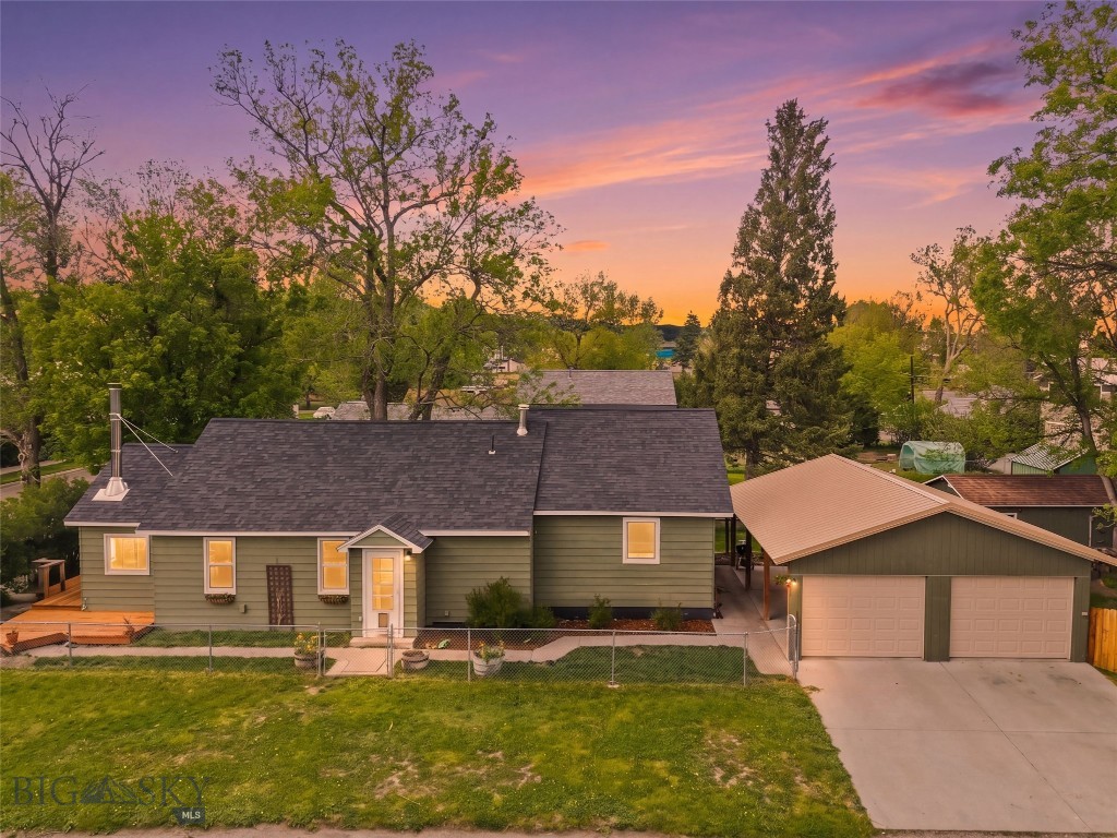Tucked into one of Livingston's quietest southside neighborhoods, this well-maintained 3-bedroom, 2-bath single level home sits on a tree-lined corner lot with mountain views and all the charm you'd hope to find in Park County. Hardwood floors and an abundance of windows bring warmth and natural light throughout, while the open kitchen and living room flow together naturally, anchored by a wood stove that makes winters cozy and inviting. Step out onto the deck and catch those legendary Absaroka sunsets. Stainless steel appliances, a new roof (2022), and move-in ready condition mean you can settle in and start living — not renovating.
The detached 1-car garage handles storage and projects, while the 3-sided carport pulls double duty as a covered outdoor patio all summer long. Across the street sits a large historic farmstead property, keeping your views open and your surroundings peaceful. Walk or bike to downtown Livingston, the Yellowstone River, and everything that makes this town special. A rare find...schedule your showing today!