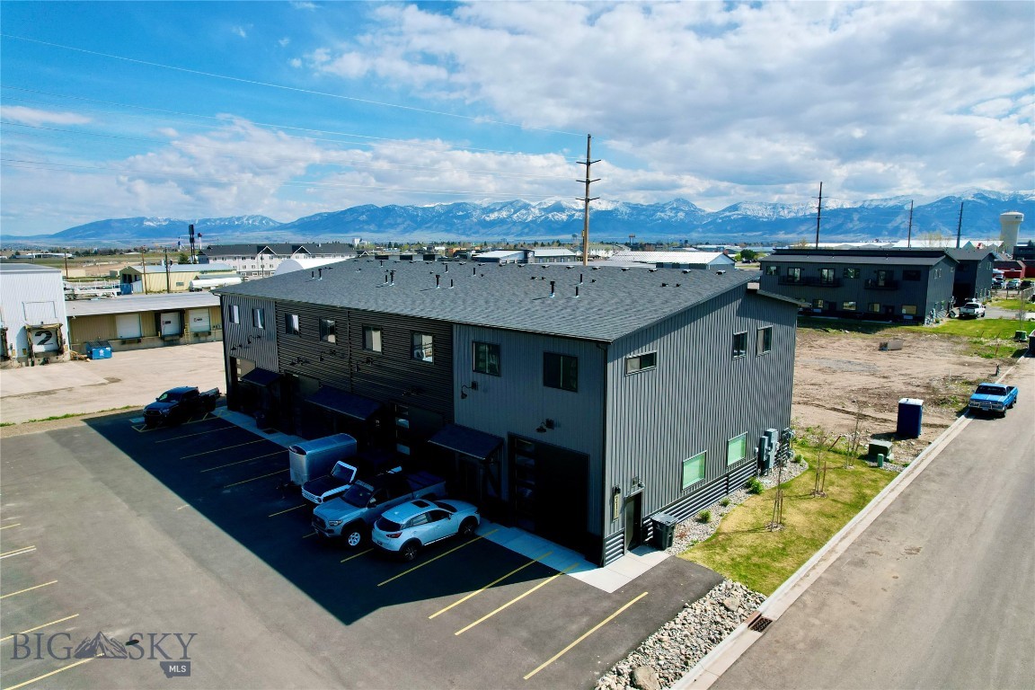 Excellent investment opportunity in Belgrade, Montana! This newly constructed live/work fourplex, positioned in one of the fasted growing communities in the Gallatin Valley, offers four mindful, well-designed units, each featuring approx. 2,400+ SF with 2 primary ensuite bedrooms, 2 full bathrooms, and an open-concept upper-level living space. Kitchens include modern finishes, large granite islands, and a quality appliance package.  Washer and dryer are included, along with air conditioning, and ample storage. Large private balconies for each unit, coupled with high caliber construction throughout.

Each unit includes a spacious heated shop 1100+ SF, with 14’ ceilings, 12’ overhead doors, epoxied floors, and separate office/studio space with a bathroom and kitchenette. Ideal for contractors, small business owners, or hobby use. 

Additional features include mezzanine storage, efficient and low maintenance materials, providing strong rental appeal. Situated on approximately 0.35 acres in a high demand corridor of Belgrade, Montana, 211 Fletching benefits from proximity to Bozeman, Yellowstone International airport, (BZN) and close proximity to Jackrabbit Lane, and I-90 interstate, making it especially attractive for small business owners and mobile workforce tenants. Shopping, dining, walking trails, are just minutes away. Excellent income with limited comparable inventory in the area. All four units are currently occupied with long term leases in place. Great option for investors or future owner-occupants seeking live/work versatility.  

This is a turnkey, income-producing asset with strong rental demand driven by its modern live/work design. With limited inventory of similar properties, this commercial four-plex represents a compelling opportunity to capitalize on the continued and inevitable growth of the Gallatin Valley while offering tenants a highly functional and desirable lifestyle solution. Call your real estate representative today, to schedule an appointment to see 211 Fletching Way!