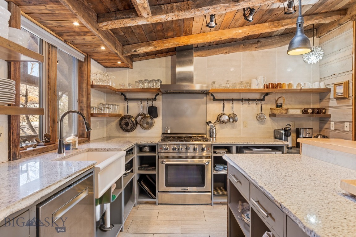 The home itself is an experience—and its extraordinary location delivers front-row seats to one of America’s most protected landscapes, Yellowstone National Park. Artist-designed and renovated with intention, this property's high-end materials and design elements have been carefully curated and collected over time, creating a sense of place that is both refined and unmistakably rooted in the American West.
Perched above the Yellowstone River on 0.33 acres, this 3,700-square-foot, 5 bedroom/5 bathroom retreat lives like a private lodge. On the main level, an authentic stacked stone surround with gas burning stove sets the tone, complemented by three ensuite bedrooms, a window-lined dining area, two inviting living spaces and covered back porch to watch the deer and antelope play.    And at the heart of it all, the high-styled kitchen—rich with old-world charm and elevated finishes—is equal parts functional and unforgettable.

Downstairs, the sun-filled lower level offers two additional ensuite bedrooms, a full laundry room, a standout bar that could easily serve as a kitchenette and a large game room designed for all ages. Step outside and gather around the fire pit to watch wildlife like never before—Bald eagles diving for trout, cow elk moving through the valley with their newborns, bison swimming across the river and antelope playing across the open fields. Currently performing as a high-end vacation rental yet equally suited for year-round living, the home offers exceptional versatility. The layout also presents potential for an upper/lower duplex-style configuration—ideal for multi-generational living or a private owner’s level with separate guest quarters.

A legacy property like this doesn’t come along often—an iconic foothold in the American West, with Yellowstone National Park as your backdrop. *Financials available upon request