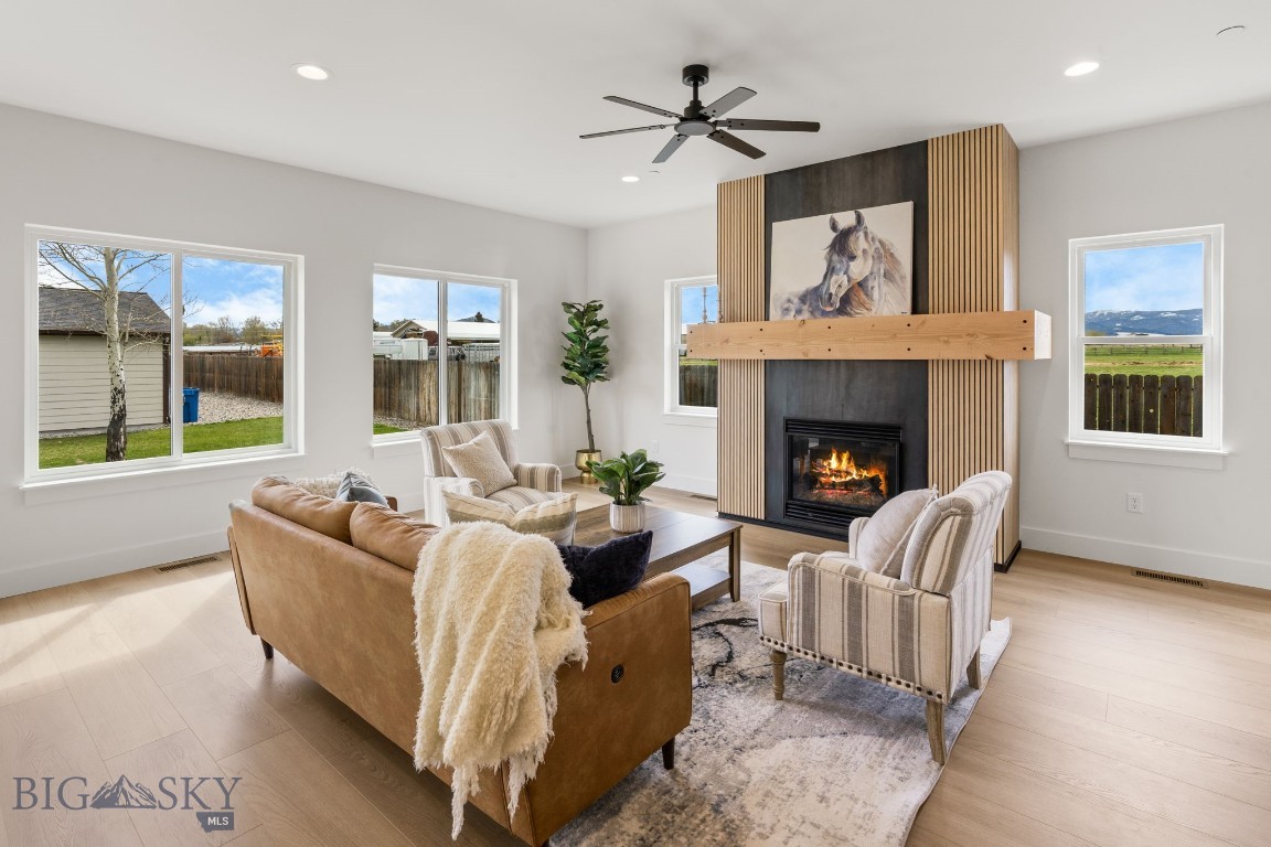 Thoughtfully designed and beautifully finished, this brand-new end unit townhouse in Falcon Hollow offers comfortable living with clean, modern style and mountain views just outside your windows. The open-concept main level creates an inviting space for gathering, featuring warm wood cabinetry, quartz countertops, stainless steel appliances, a spacious island with seating, a hidden butlers pantry generously sized, and a cozy gas fireplace anchoring the living room. Large windows bring in abundant natural light while the adjacent dining area flows seamlessly to the patio and backyard space. Upstairs, the huge primary suite offers a peaceful retreat with a dual vanity bathroom, tiled shower, and generous walk-in closet. Two additional bedrooms, a full guest bath, and an upstairs laundry room provide a functional layout designed for everyday living. Additional highlights include vinyl plank flooring, an attached two-car garage, and contemporary finishes throughout. Conveniently located on Bozeman’s west side with nearby parks, playgrounds, sidewalks, and easy access to Huffine, this home combines low-maintenance living with modern comfort and style. This home is in the process of being approved for townhome status.