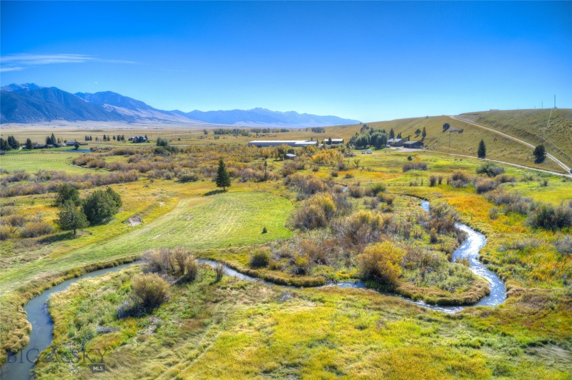 Three Buildable 5+ Acre Parcels • Bear Creek Frontage • Minutes to Ennis
A rare opportunity to own 15.65 scenic acres divided into three buildable parcels, ideal for investment, residential, or a multi-home retreat. Bear Creek is a fishable spring creek that runs through the property, adding year-round beauty, peaceful sounds, and attracting abundant wildlife.

Enjoy breathtaking mountain views, privacy, and a serene setting, all just minutes from downtown Ennis. The property borders the Longhorn Ranch, protected by a conservation easement, helping preserve the surrounding open space and views.

Opportunities like this, with water, acreage, and proximity to town, don’t come along often.