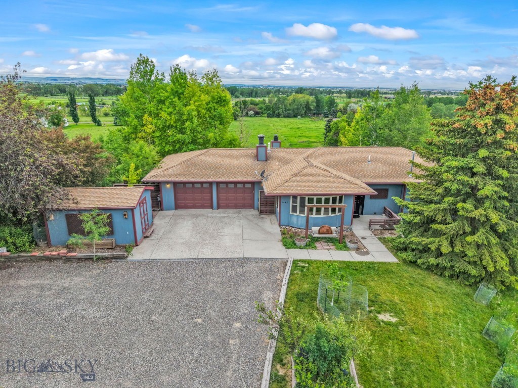This home is absolutely overflowing with potential!  Close up views of the Bridgers in the front and the Tobacco Roots in the back are captivating.  It feels like you're on the top of the world!  Spacious deck off the back makes it so that you can easily enjoy meals or a good book with those magical views in the background.  12 minutes to downtown.  Put your personal spin on it or move in and begin enjoying it immediately.  1.5 acres of rolling green lawn creates a private oasis at this property on a point.  Mature trees and hedges give it seclusion and an established feel. Inside, two separate living areas makes it so that everyone can enjoy their own thing.  Beautiful stone fireplaces on each floor create a cozy feel.  Large windows let in natural light from every angle.  Tons of square footage make this home work for so many different applications, plus plenty of storage space, including a standalone shed outside with power.  Long driveway and several parking spaces make entertaining a breeze.  Found at the end of a cul-de-sac, it's truly one of a kind.  Once you'll see it, the value will be clear.  This is a home that has the potential to be a true show piece.