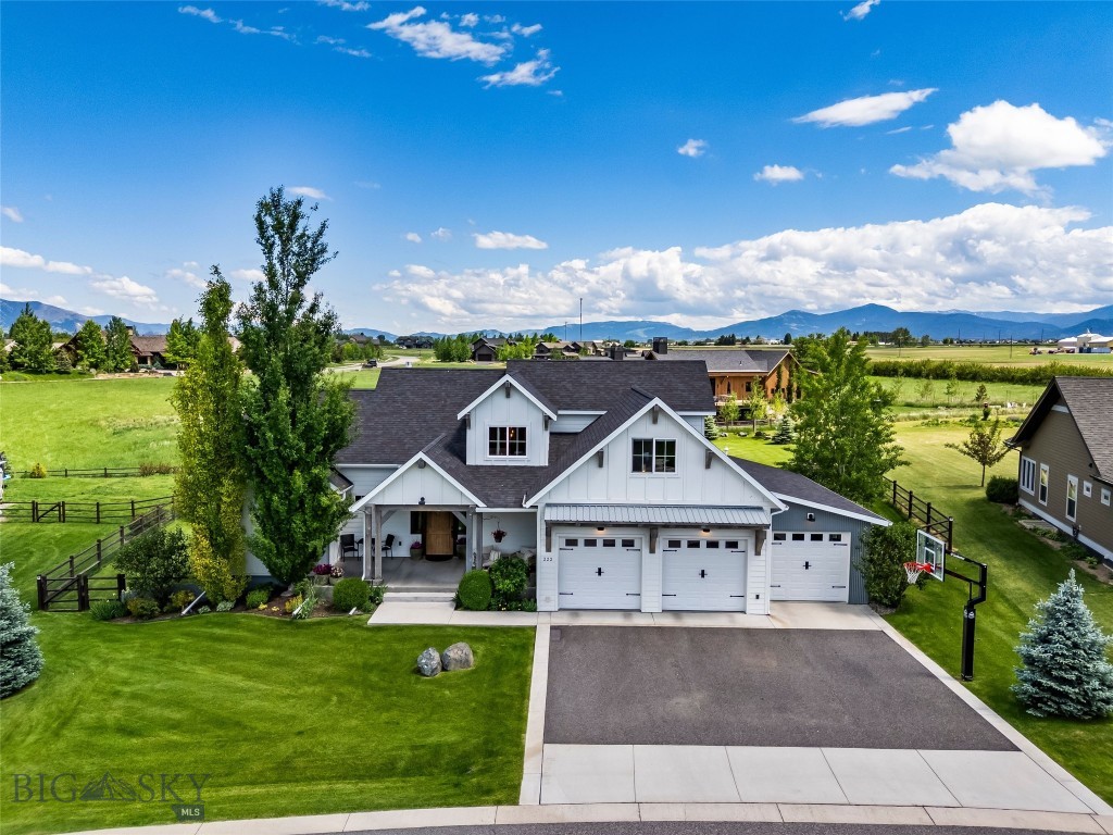 Welcome to one of Middle Creek Parklands' most exceptional offerings.
Positioned on one of the community's premier lots, this custom-built residence combines timeless craftsmanship, thoughtful design, and an extraordinary outdoor setting that is rarely found within greater Bozeman. Meticulously maintained by its original owner since its completion in 2016, the home reflects a level of care and pride of ownership that is immediately apparent.
Designed to embrace its remarkable surroundings, expansive windows fill the home with natural light while perfectly framing breathtaking sunrise views and mountain ranges across the valley. Whether enjoying your morning coffee from the main living spaces or unwinding in the hot tub, the scenery provides a daily reminder of why this location is so coveted.
The main level features a spacious primary suite and an open-concept living, dining, and kitchen area designed for both everyday living and entertaining. Custom woodworking, reclaimed architectural elements, and a striking fireplace surround create warmth, character, and a sense of enduring quality throughout the home.
Upstairs, you'll find two additional bedrooms, a full bath, and a versatile third room ideal as a bedroom, office, or flex space. The daylight lower level serves as the ultimate gathering space, complete with a large recreation room, TV lounge, wet bar, stained concrete floors, two additional bedrooms, a full bath, and a half bath. High ceilings and abundant natural light make the lower level feel every bit as inviting as the main floor.
Outside, the property truly shines. The park-like backyard borders the renowned Black Bull community and offers exceptional privacy, mature landscaping, abundant perennials, established trees, expansive lawn space, and a beautifully designed custom patio perfect for entertaining, relaxing, and enjoying Montana's four seasons.
Located in one of the Gallatin Valley's most sought-after neighborhoods, residents enjoy a strong sense of community, extensive trails, parks, and the convenience of being within walking distance of Monforton School.
A rare opportunity to own one of Middle Creek Parklands' standout homes—where exceptional craftsmanship, an extraordinary setting, and an unmatched lifestyle come together.
