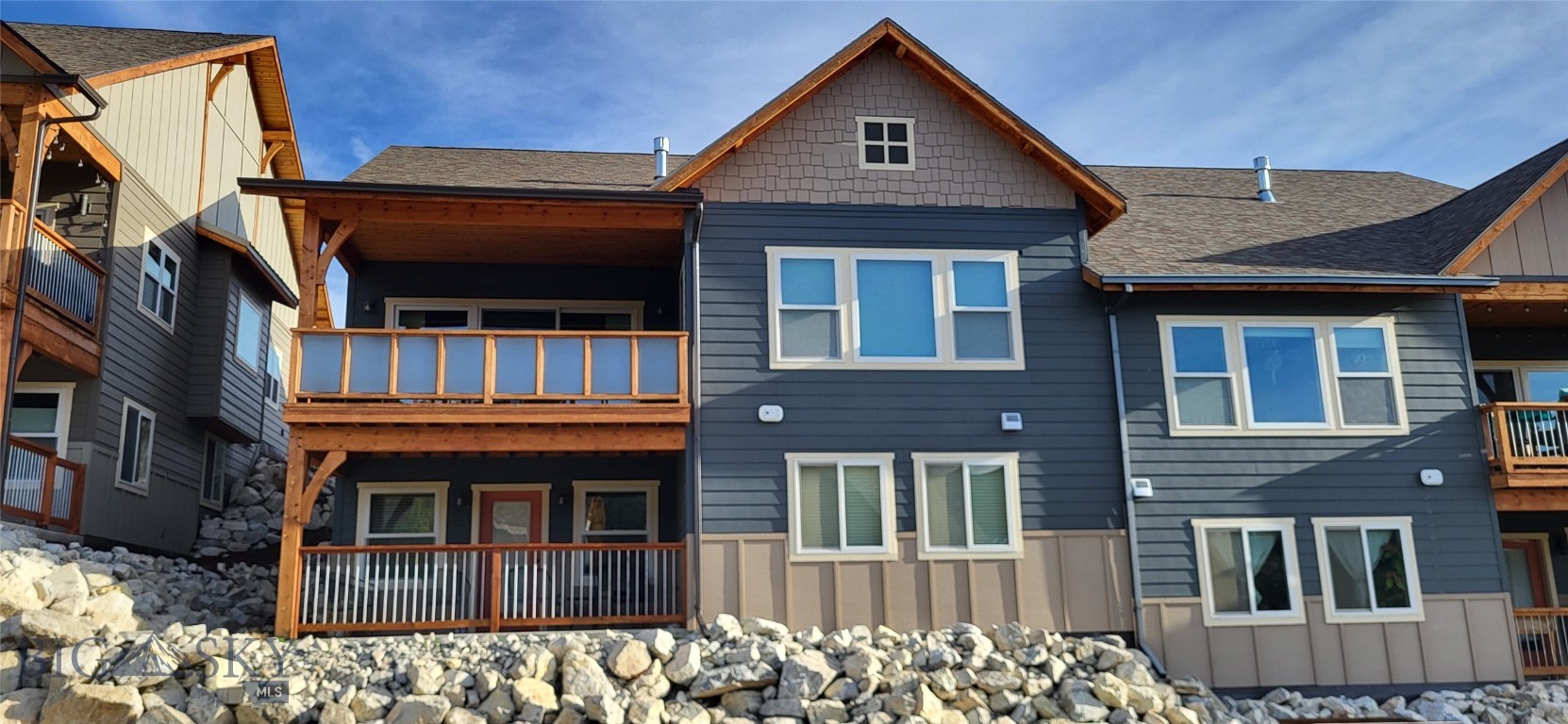 Positioned in a quiet, well-maintained community, this immaculate condo delivers exceptional value with panoramic mountain views, true main-level living, and a prime location just minutes from the hospital and trail access. Designed for ease and quality, the home features zero-step entry, new central air, updated disposal, comfort height toilets, and water circulation pump, plus abundant storage throughout. Highlights include hardwood floors, granite surfaces, custom cabinetry, a gas range, and a generous pantry accented by warm timber details. The open-concept main level offers two bedrooms and two full baths, along with a covered deck off both the living area and primary suite—ideal for enjoying Montana’s scenery year-round. The walk-out lower level expands the living space with two additional bedrooms, a full bath, and a large family room opening to a covered patio. A rare blend of low-maintenance living, comfort, and access to an active lifestyle.