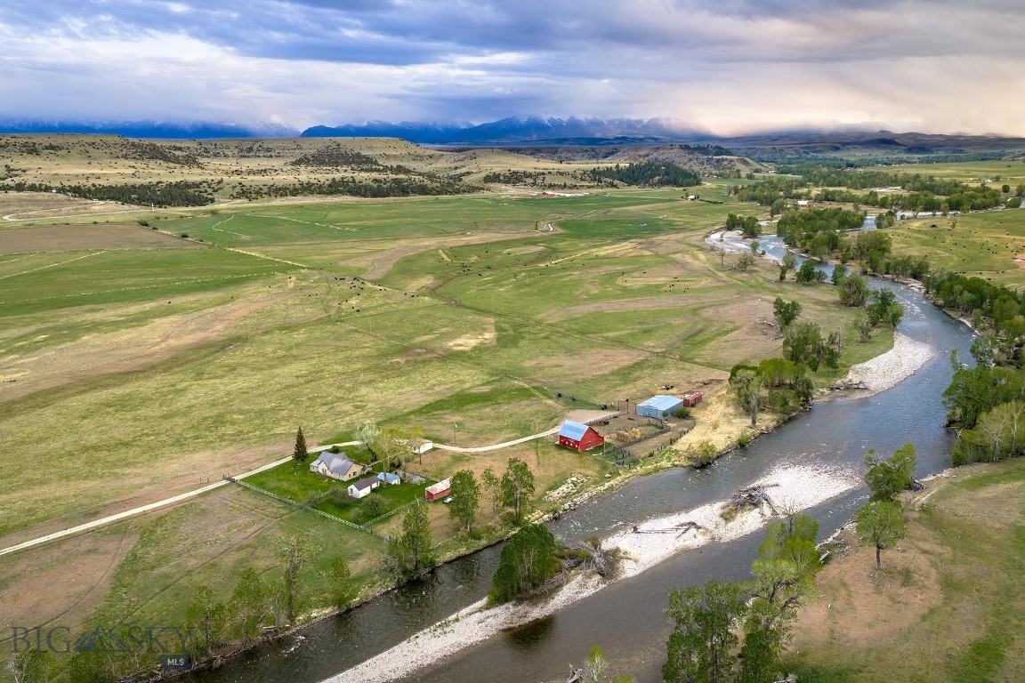 Stillwater Riffle Ranch is a rare offering along one of Montana’s most celebrated trout rivers, combining productive acreage, exceptional live water, and a highly accessible location just south of Columbus. Spanning approximately 158± acres, the ranch is anchored by roughly 1,600± feet of Stillwater River frontage forming its entire northern boundary, classic riffle water that supports healthy populations of rainbow and brown trout on a renowned blue-ribbon fishery.

Beyond the river, the property features approximately 92± irrigable acres with water rights diverted from the Stillwater via the Roadhouse and Nichols Ditches, providing meaningful agricultural productivity and long-term upside. The balance of the land offers open ground, riparian habitat, and sweeping views that define this stretch of Stillwater Valley.

Improvements include a comfortable, modest headquarters with a three-bedroom, 1.5-bath residence offering approximately 1,523± square feet. Originally built in 1900 and updated in 1980, the home enjoys expansive views of the Beartooth Mountains and is complemented by a detached garage. Classic ranch infrastructure rounds out the improvements, including a quintessential red barn, equipment shed, and additional storage buildings that support both agricultural and recreational use.

Currently leased for production and grazing to a local rancher, Stillwater Riffle Ranch offers immediate operational continuity with flexibility for future ownership vision. With close proximity to Columbus, easy access to Red Lodge and Yellowstone Country, and under an hour to Billings and major air service, this is a scarce blend of Blue-Ribbon water, productive ground, and an easy-to-enjoy Montana basecamp.