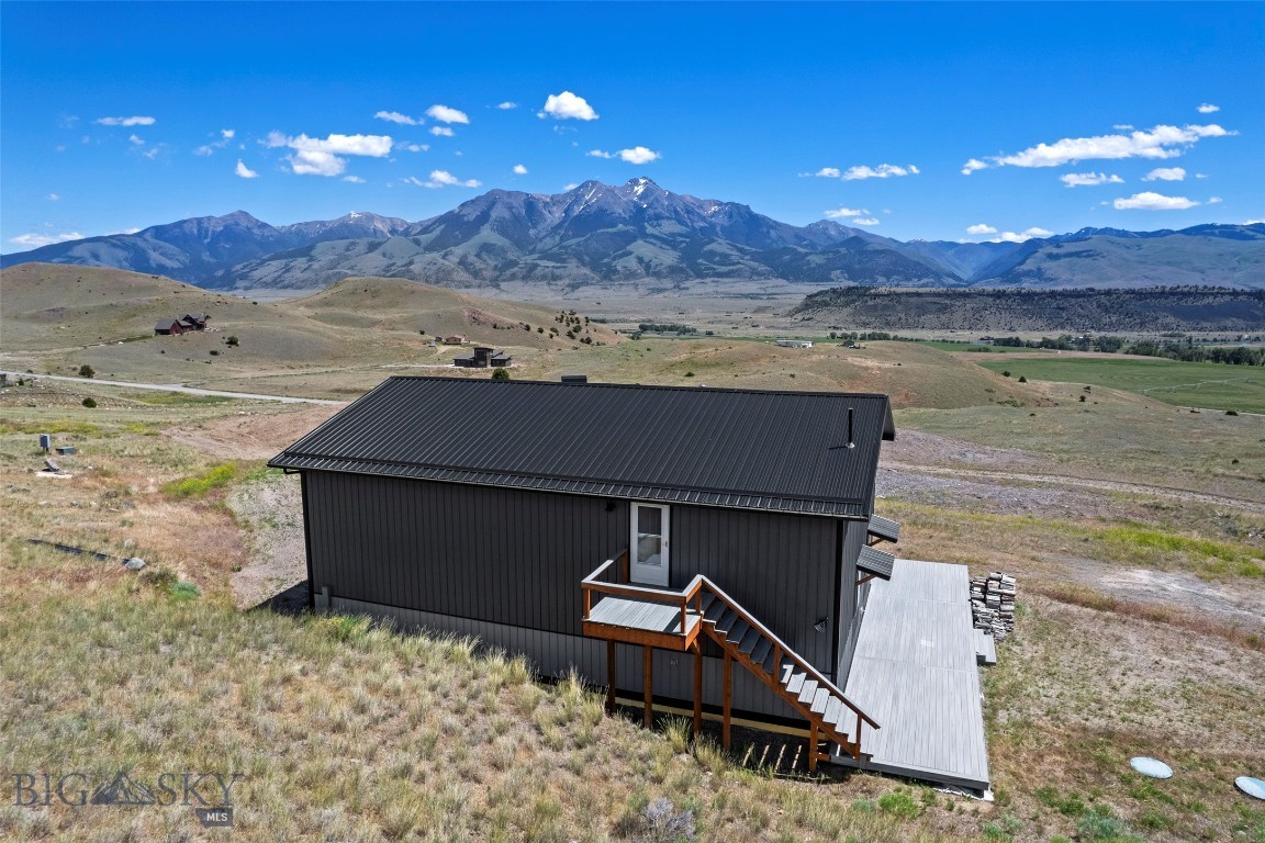 This is your chance to own your Montana dream retreat on 19 acres in scenic Paradise Valley. Opportunity to live in the current home while building your dream property right next door. This property offers unmatched views of Emigrant Peak, Electric Peak, Dome Mountain, and the breathtaking expanse of Paradise Valley. Current residence is a 2022 build, featuring 2 bedrooms, 2 full bathrooms, great kitchen and open living space with views out every window. A 1,000 square foot attached garage shop space with Hearthstone Castleton high-efficiency wood stove, two 14’ insulated garage doors, 192 square foot loft with storage and workspace with 30-amp and 50-amp service, and 50-amp RV hookup outside. Take in all the views on the 1,000 square foot trex wraparound south facing deck, while still enjoying great privacy. This property is ready for a new owner to be able to build a new home next to the current home on the property. With extensive excavation already completed, separate electrical service installed for the future home, a high-producing well (12 GPM, 660’ depth, 68°F average temperature – ideal for geothermal heating and cooling), a new owner can use the premier building site with completed architectural plans for a custom 3,000+ square foot home or come up with a new concept. Unbeatable location being 2 minutes from the Yellowstone River, 10 minutes from Chico Hot Springs, 20 minutes to Yellowstone Hot Springs, 30 minutes to the North Entrance of Yellowstone National Park, 30 minutes to Livingston MT, and 45 minutes from Bozeman MT. Properties like this one don't come along often, don't wait to call this one home!