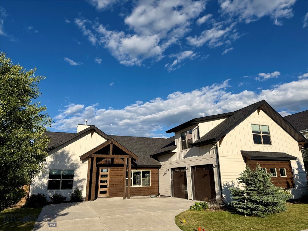 Designed and constructed by Black Diamond Development, this home is a refined and well-finished example of the modern farmhouse aesthetic designed to capture strong Bridger Mountain and park views. The home is characterized by its "mostly main floor" configuration, with more than 3/4 of the living space situated on the ground level. This layout provides the convenience of single-story living while maintaining a distinct, separate upper-level suite with a full bathroom, a separate mini-split system, and easy access via interior stairs. The living room, kitchen window, primary bedroom and one of two additional main-floor bedrooms face the Bridger Mountains. A custom-built mantle serves as a vertical focal point, extending from the fireplace to the ceiling line. The kitchen is designed for high-capacity culinary use, anchored by a 64-inch (wide) professional-grade refrigerator and freezer. Cabinetry extends to the ceiling and is paired with white quartz countertops, a tile backsplash, and LED under-cabinet lighting. A custom-built hood provides a clean visual finish above the range. The oversized center island includes the sink and has a significant workspace that serves as the transition between the kitchen and the living room and dining area. The primary suite has a free-standing tub, and a trough sink with dual faucets. The primary shower is fully tiled across the walls and the ceiling. The second floor can be used as a bonus room or fourth bedroom with a bathroom and the room uses a separate mini-split system to ensure climate control independent of the main floor. Within the past five years, a whole-house air conditioning system and a humidifier were integrated into the HVAC system. This is a smart home: WiFi-enabled full-house water shut off, garage doors, and sprinklers; smart thermostat; robust Simplisafe security, including: interior and exterior cameras, window and door sensors, glass-break detection, a smart thermostat, a low-temp sensor, and moisture sensors at each interior location with water. The property is very well located within northwest Bozeman. The home is within walking distance of Gallatin High School. It sits just west of the 100-acre regional park. The park contains the 17-acre “Lewis and Bark” dog park that includes a pond with a dock, and the larger park has two additional ponds and a trail that connects to Bozeman's 80+ mile "Main Street to the Mountains" interconnected trail system.
