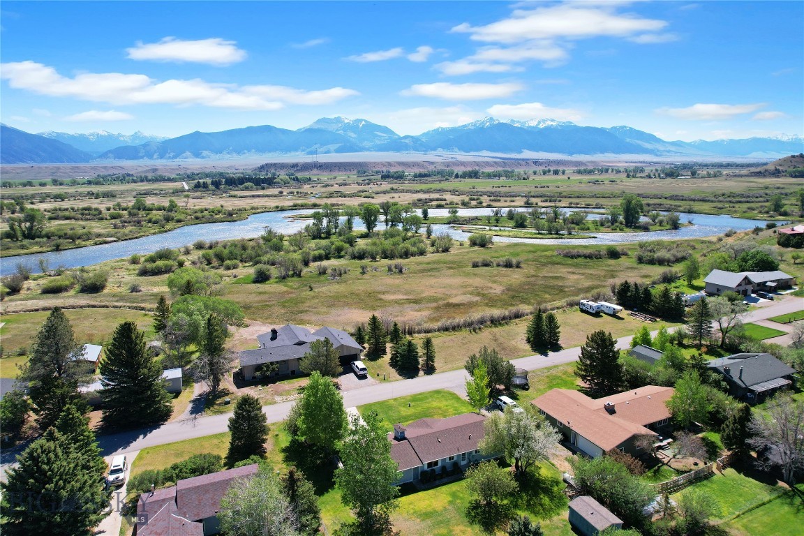 Incredible location in lower Ennis as this home is only a stone's throw from the Madison River, only a few blocks from downtown, and less than an hour to Bozeman's International Airport and Yellowstone National Park.  The "upper bedroom - bath" ensuite is large, roomy, has a walk-in closet and is located in such a way as to give the "master" of the house increased privacy.  There is a second bedroom that is large enough to be your guest room as well as your office.  Fiber Optics is already in the home that creates a great option for a live-work unit.  There are decks off both the back and front (east & west sides of the house) and the back yard of this 1/3+ acre lot is chain link fenced - ready for your dogs.  There is an attached one car garage (with additional storage in a lean to) as well as a utility shed.  The Madison Valley is home to elk, deer, mountain goats, moose, big horn sheep, and a million +/- trout.  Big Sky snow skiing is just over the mountain, snowmobiling is south of Ennis, hiking - biking - horseback riding trails are found everywhere.  In Montana you don't just buy a property - you purchase a new lifestyle!!
