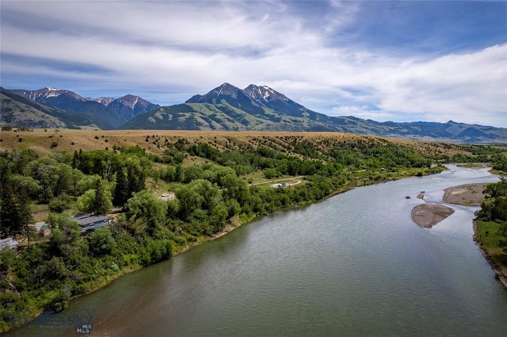 15 Acres with 1,750+- of Yellowstone River Frontage. This incredible 15 acres has springs, trees, meadows, river views and frontage - two awesome sites with good septic systems. The 1931 home was once the historically famous Wanigan, a beloved cookhouse originally used by river workers on the Yellowstone. Used as a residence for many years now, the home is in rough shape with strong potential. Besides the home, there is a river front build site with approved septic that truly captures the Yellowstone River and beauty of Paradise Valley (currently a mobile home not owned by seller has a $500 a month lease until May 2027 on this site). The property has East River Road separating the river front property from the beautiful land adjoining Sage Lodge that is a rich habitat for a variety of wildlife. Both homes are serviced by spring water. Enjoy the pictures and with this great price on a rare Paradise Valley and Yellowstone River property - consider it an opportunity for the right person!