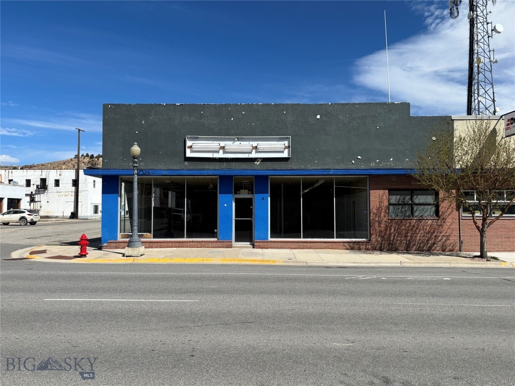 Looking for a space for your new or existing business? This 7,000 square foot building offers high visibility and easy access, ideally located on Commercial Street in Anaconda along the main road into town. The property features large front windows, making it well-suited for retail or showroom use, along with a spacious open floor plan that allows for flexible layout options. Additional features include office space, counters, a potential break room area, a secure room with keypad lock and ample storage in the rear. A large commercial door at the back provides convenient access for deliveries, inventory, or equipment. This versatile space presents an excellent opportunity for a variety of business uses.