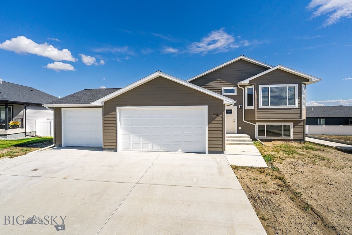 Bring your toys!! Large 3 Car Garage!! Welcome to this beautiful new construction home! An inviting entryway leads up to a spacious living room with expansive windows that fill the area with natural light. The open concept design flows seamlessly into the kitchen, complete with abundant storage, a large corner pantry and direct access to the dining area. Open the big sliding door and step out onto the deck - ideal for entertaining or enjoying quiet
evenings. The upper level includes a private primary suite with an attached bath and generous walk in closet. An additional bedroom and full bath complete this level. The lower level of this home features a large family room, 2 additional bedrooms and full bath all with daylight windows! This home is a must see! *PHOTOS OF A SIMILAR  HOME